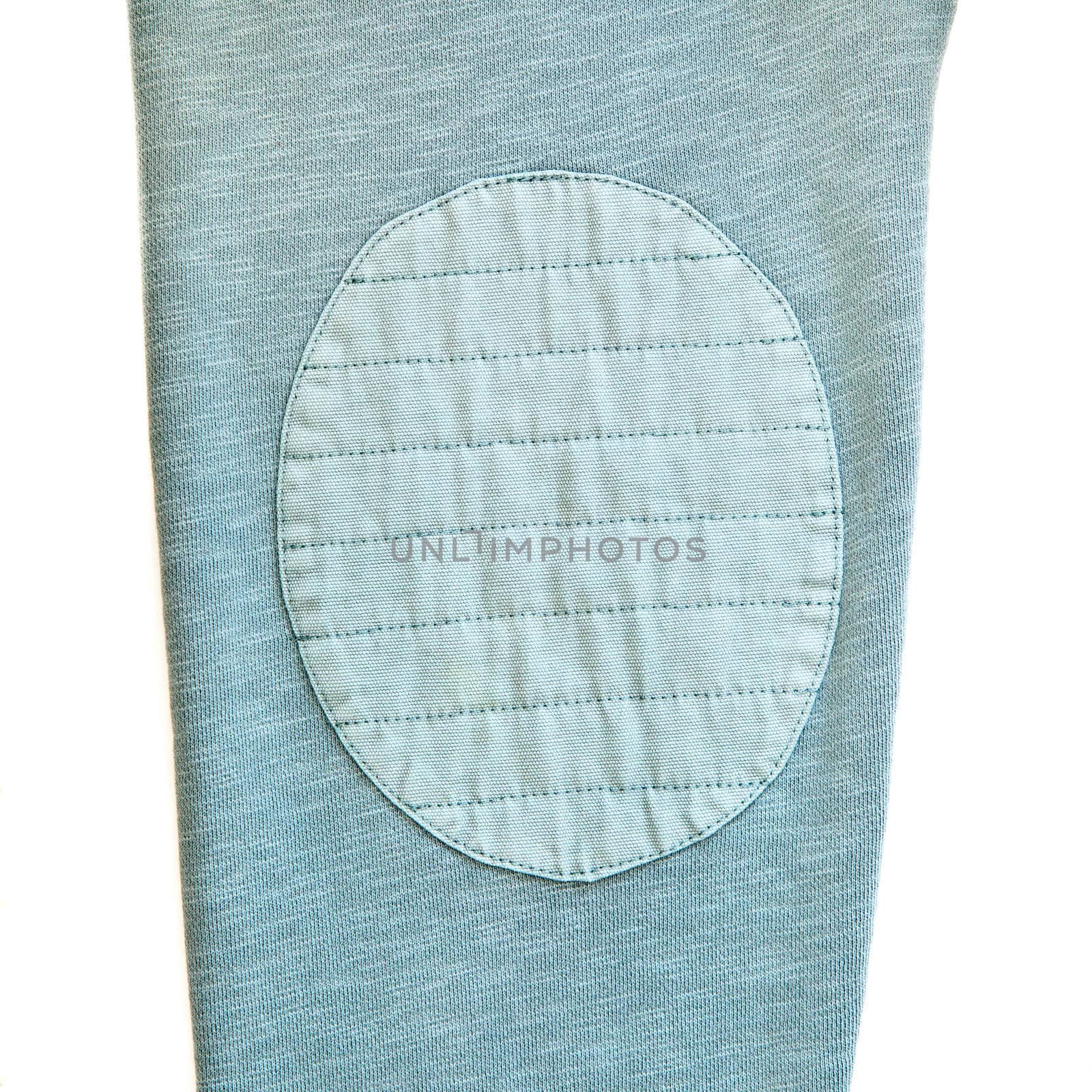 An elbow patch on the sleeve of a green casual top