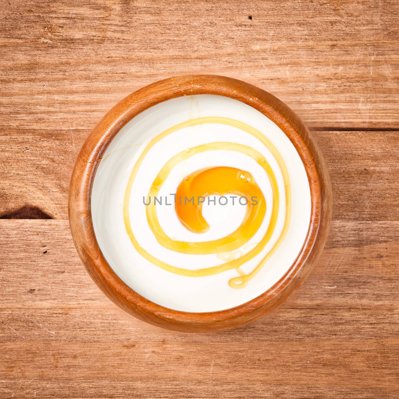 A bowl of greek yogurt with honey