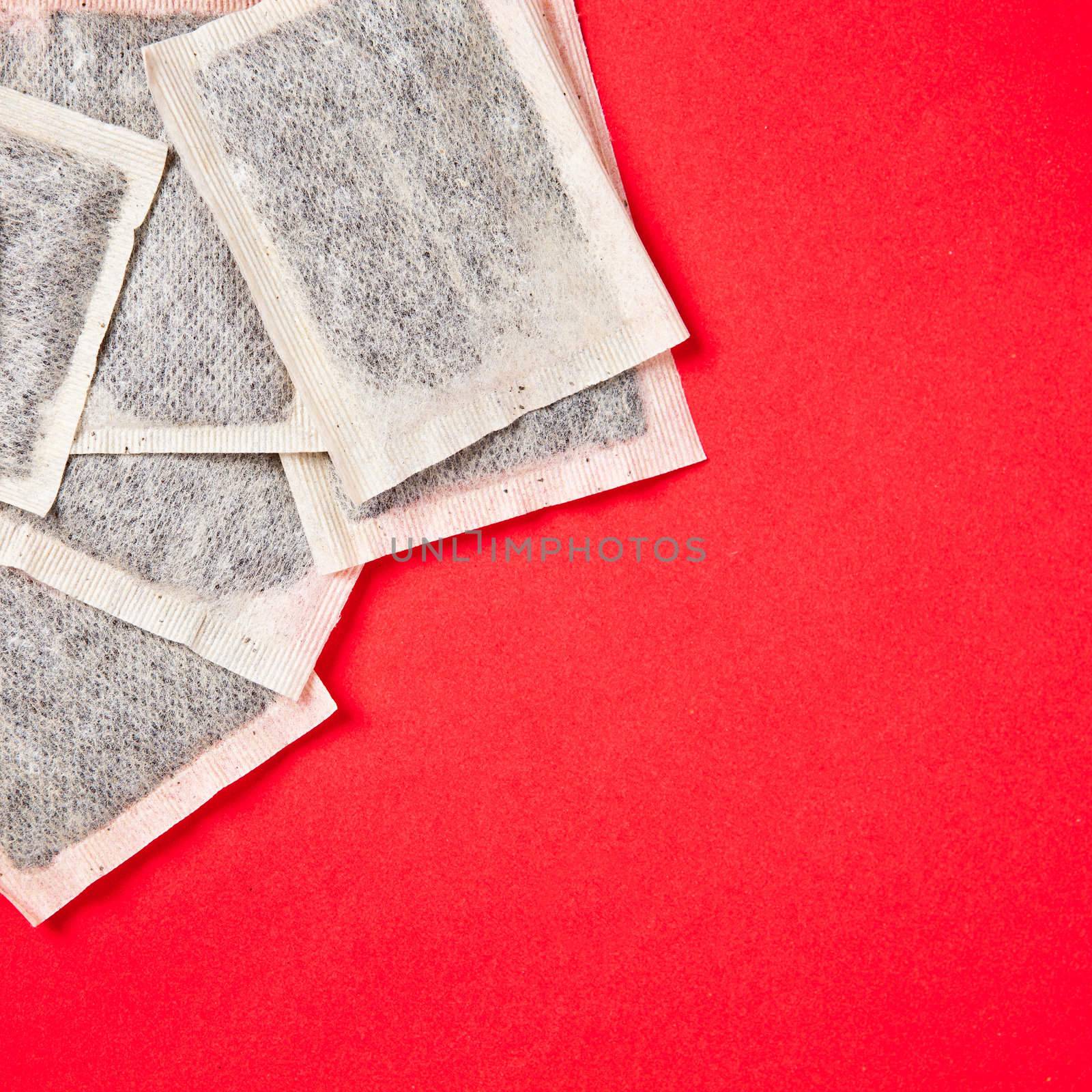 New tea bags on a red background