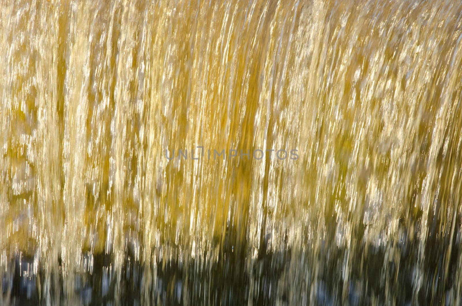 Flow down dam water closeup beautiful sunlit backdrop background.