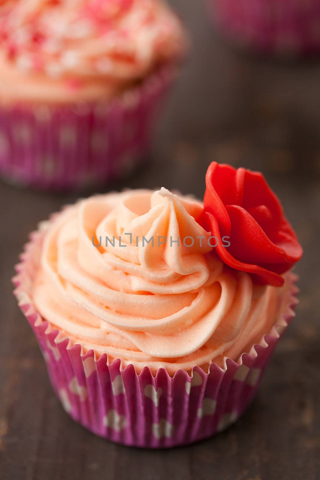 Close up of birthday cupcake decorated with rose of marzipan