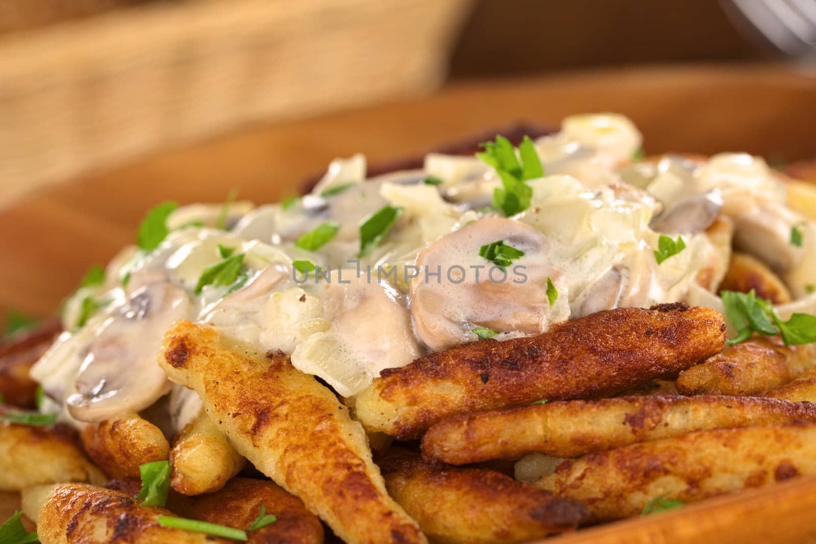 Schupfnudeln (Swabian potato noodles from Southern Germany) with mushroom sauce (Very Shallow Depth of Field, Focus on the front of the mushroom sauce) 