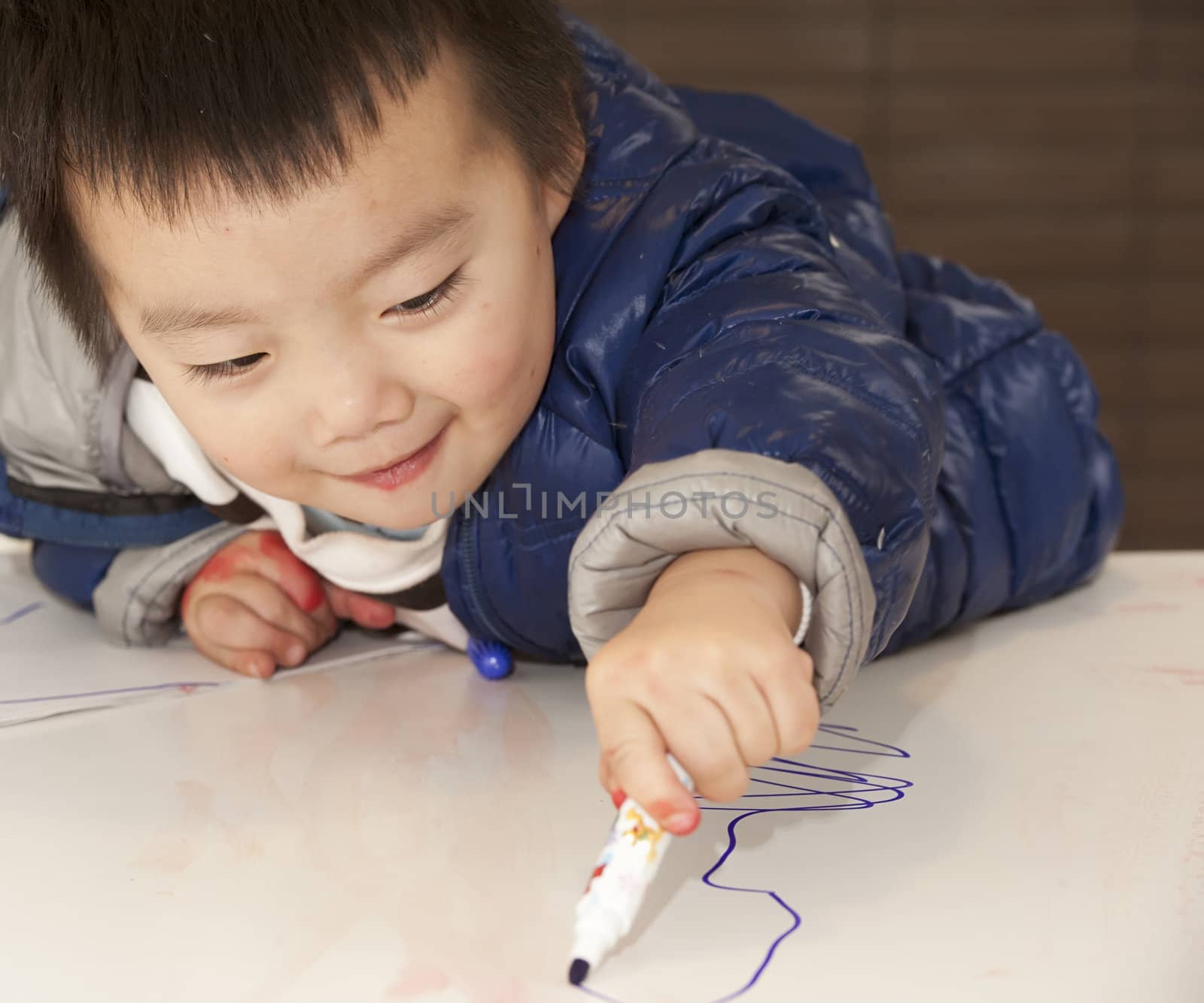 a cute baby is painting on the table by jackq