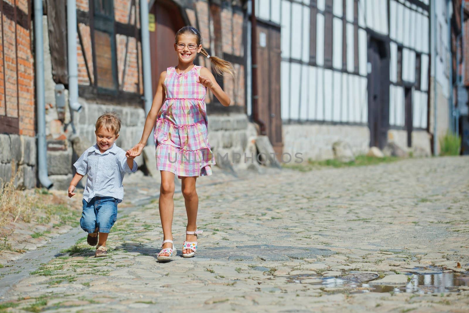 Cute little boy wiht his sister outdoors in city