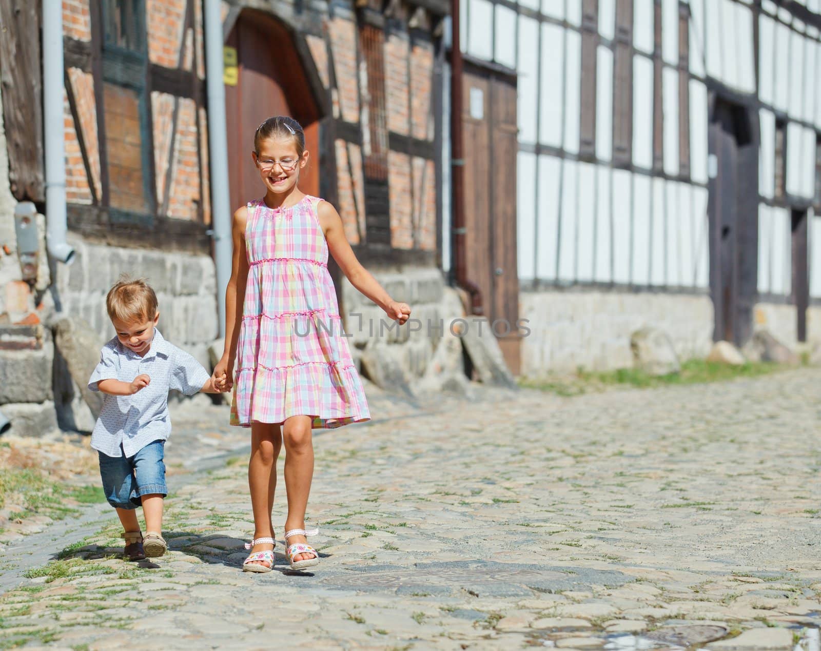 Cute little boy wiht his sister outdoors in city