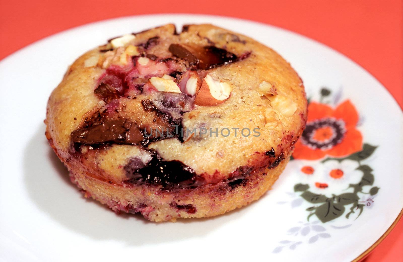 Muffin cake on the dessert plate with red background
