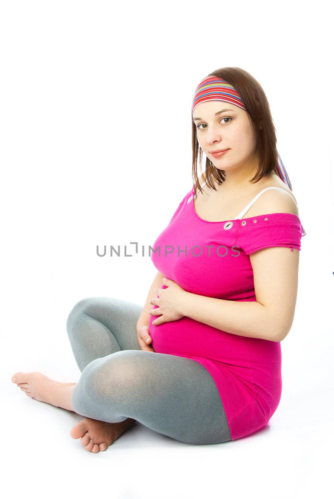 portrait of a beautiful young pregnant woman sitting on the floor