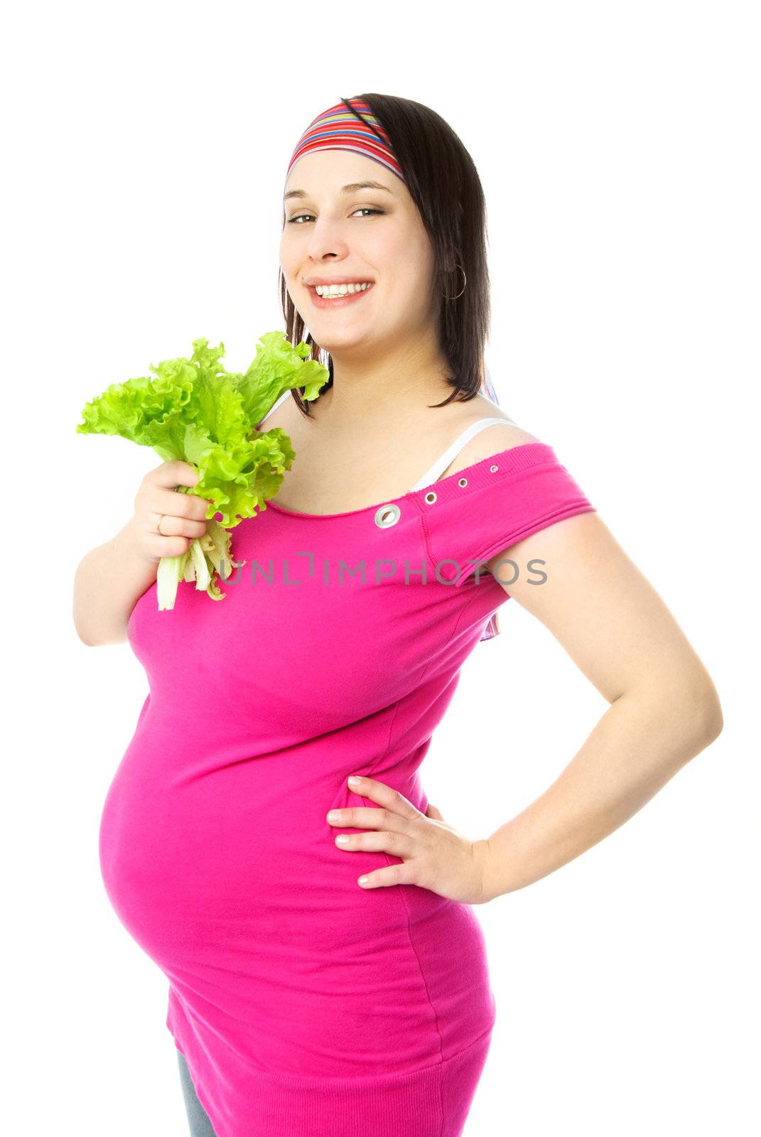 portrait of a happy young pregnant woman eating green salad
