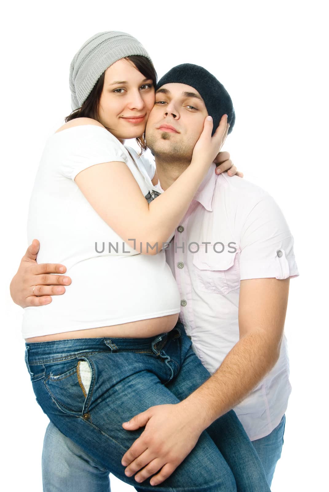 happy family, young man and his pregnant wife embracing