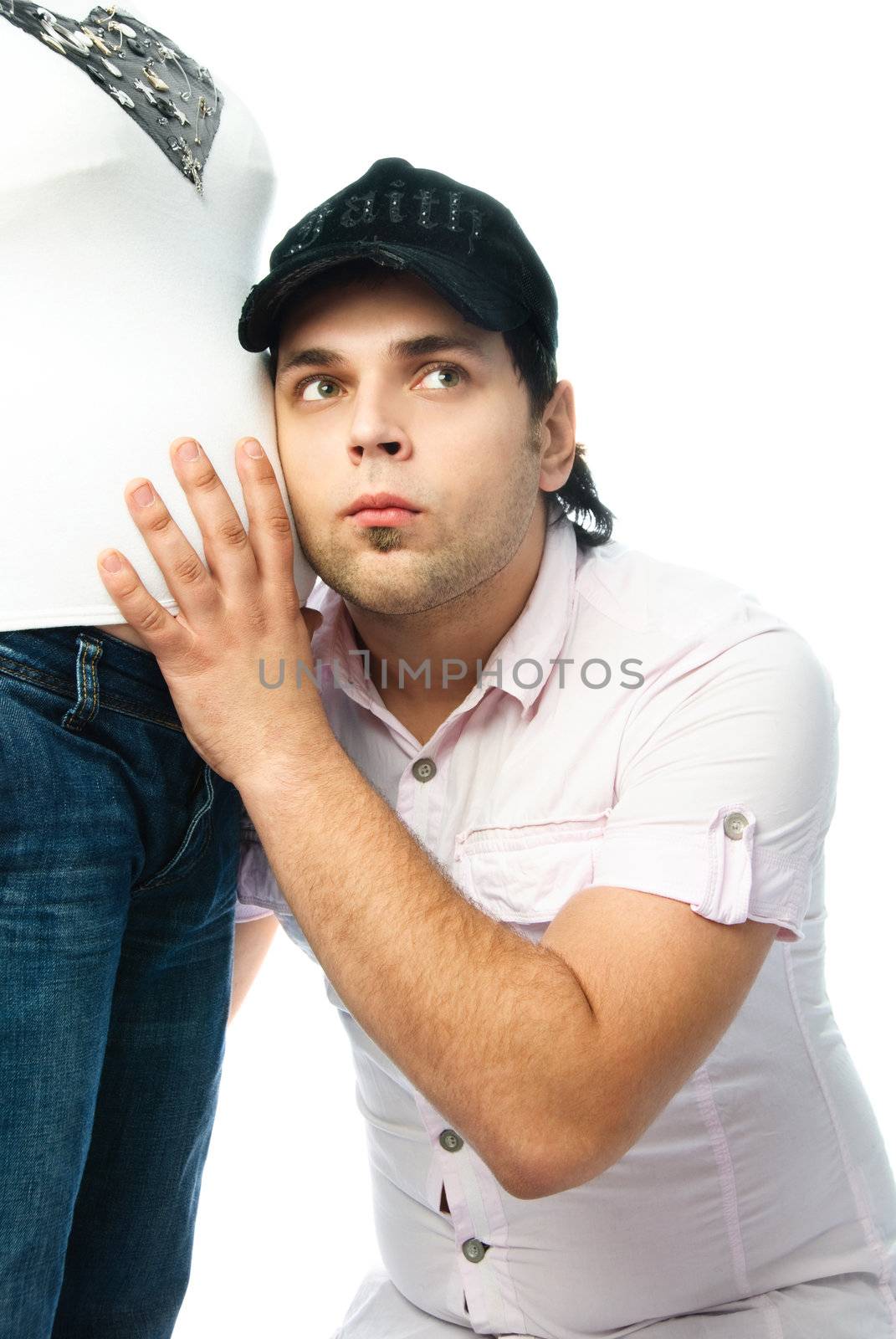 young father listening to his future baby isolated against white background