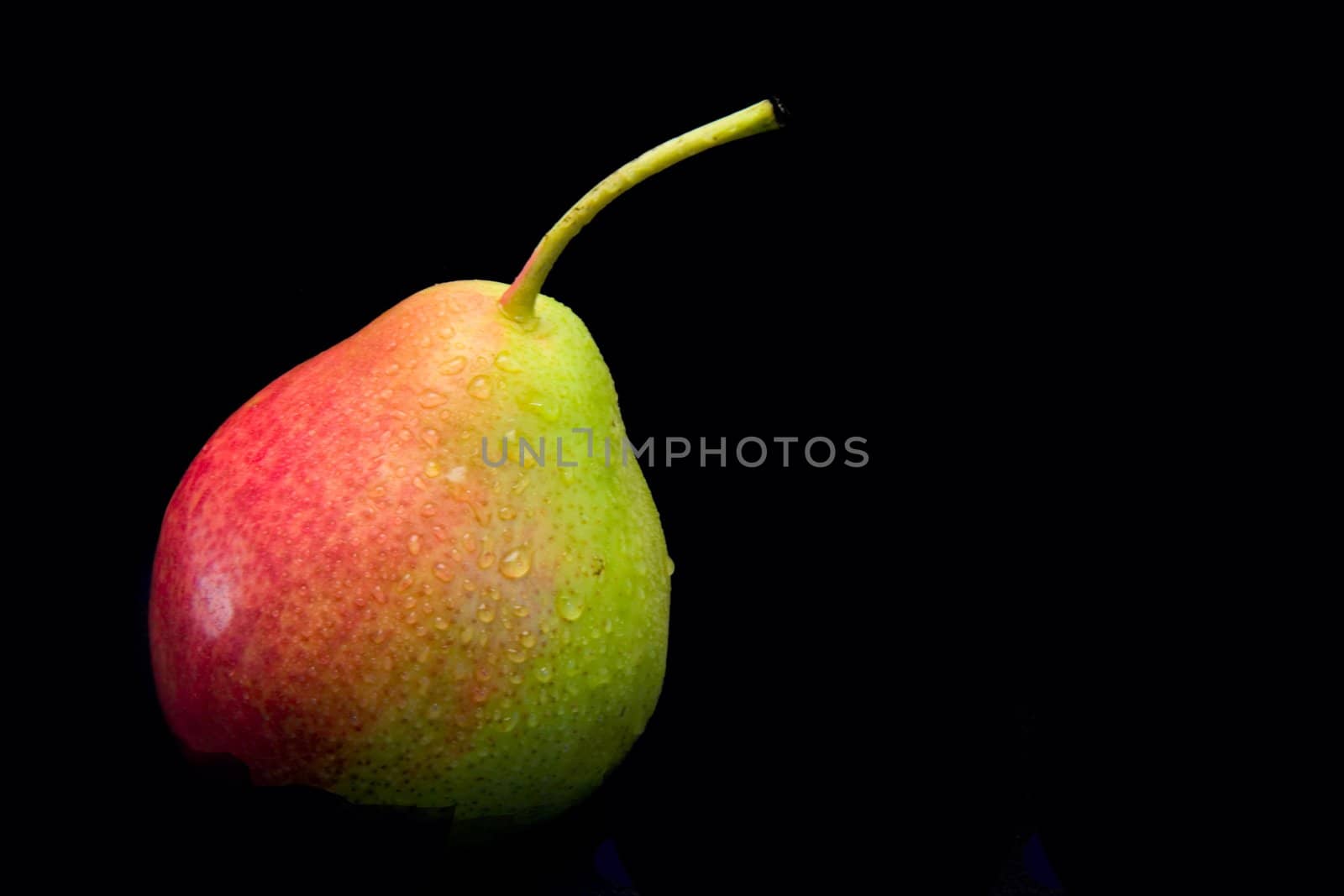 A delicious red pear with water drops