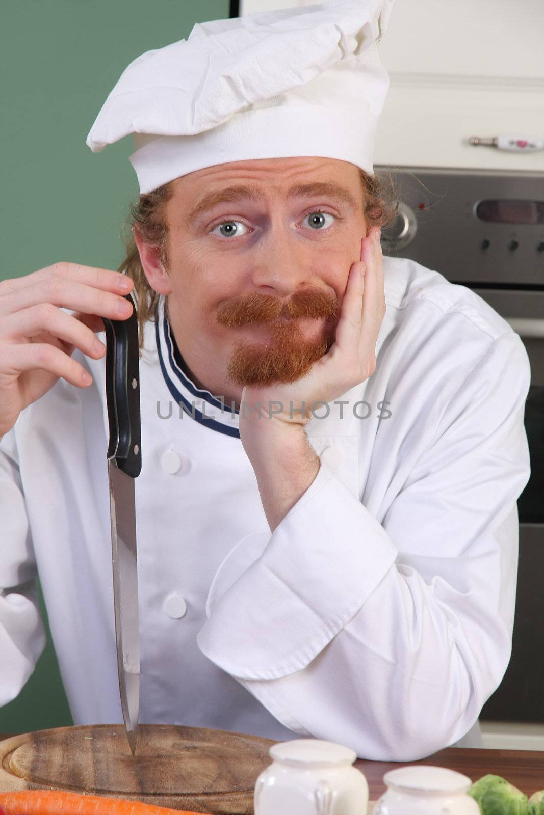 Young chef with a knife, thinking for prepare lunch