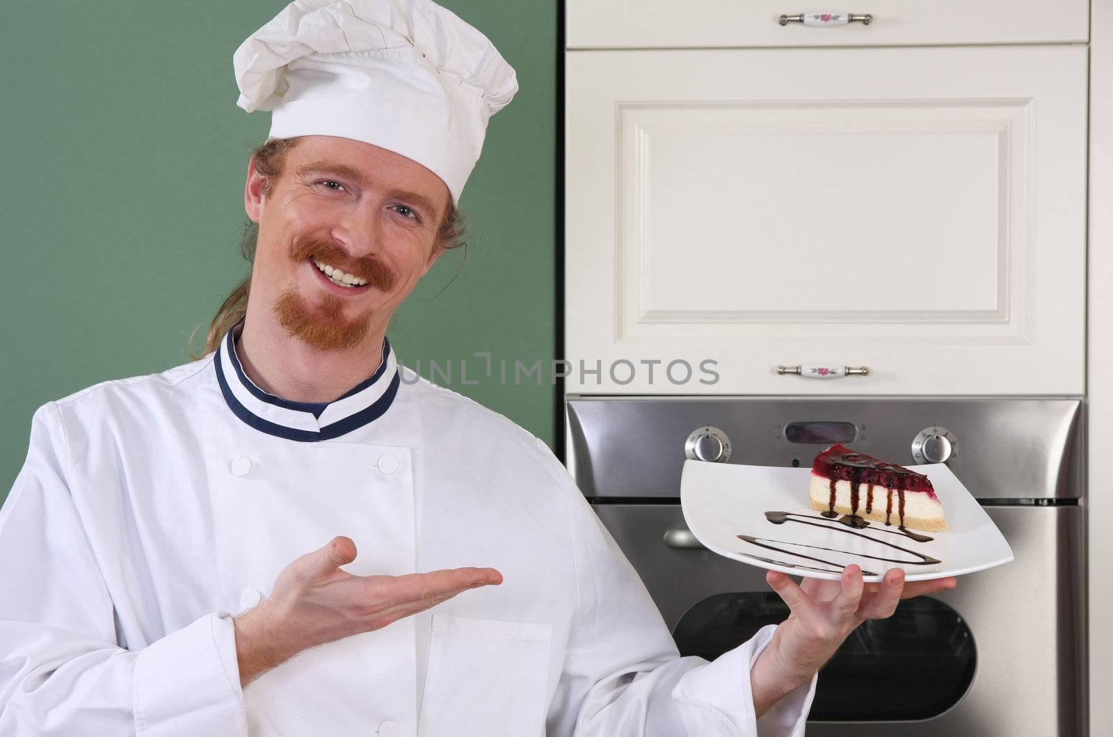 Young chef with piece of cake with chocolate sauce