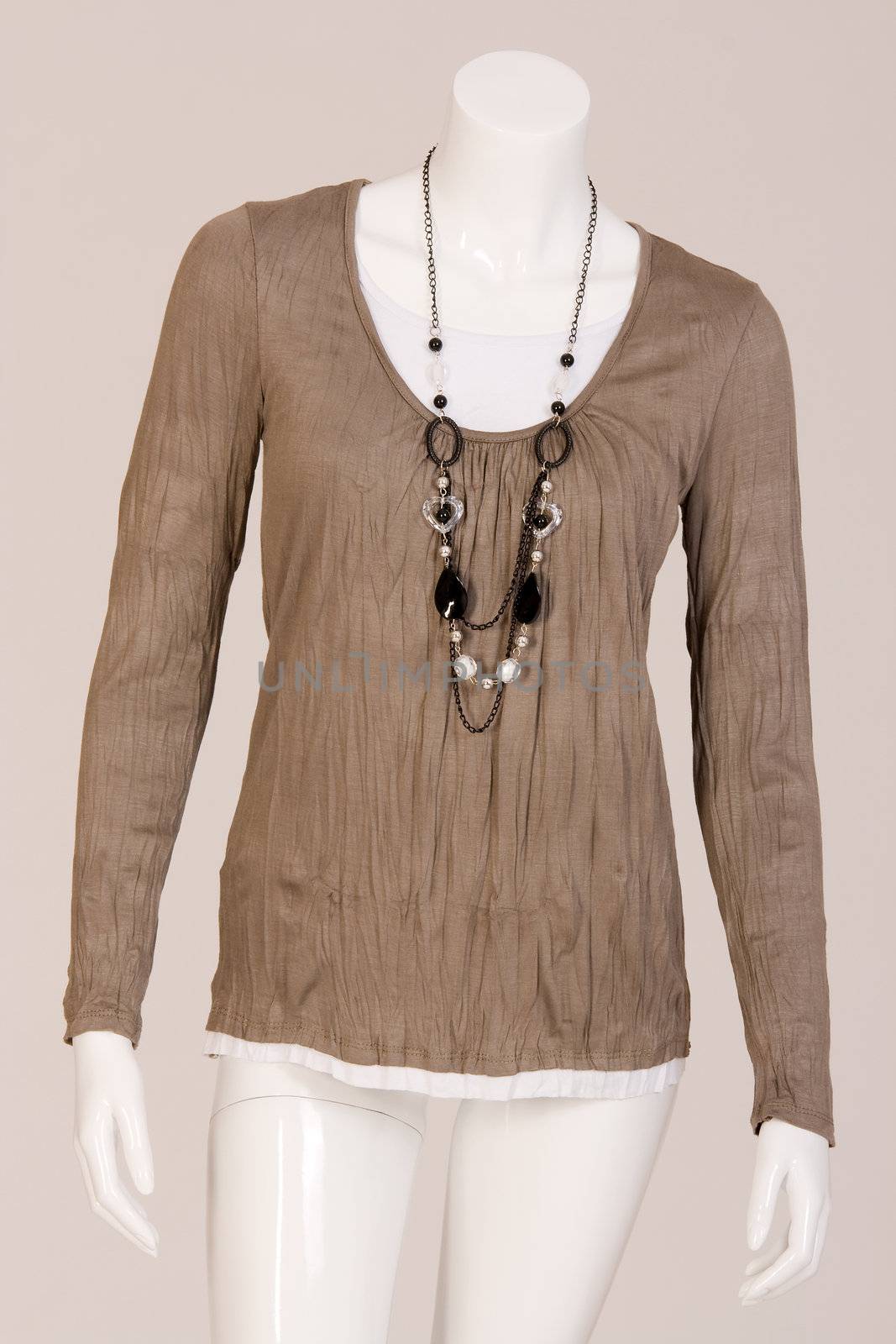 Mannequin dressed in a beige shirt and fashionable chain