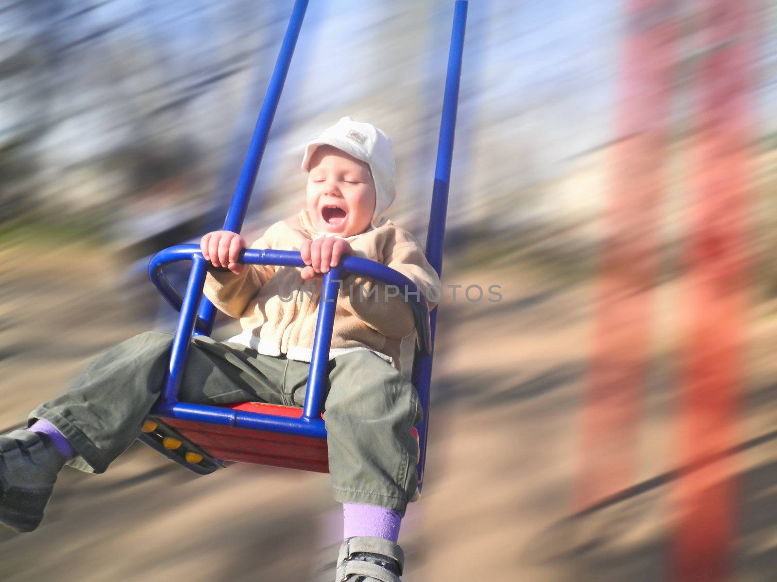 Enthusiastic kid on a swing by NickNick