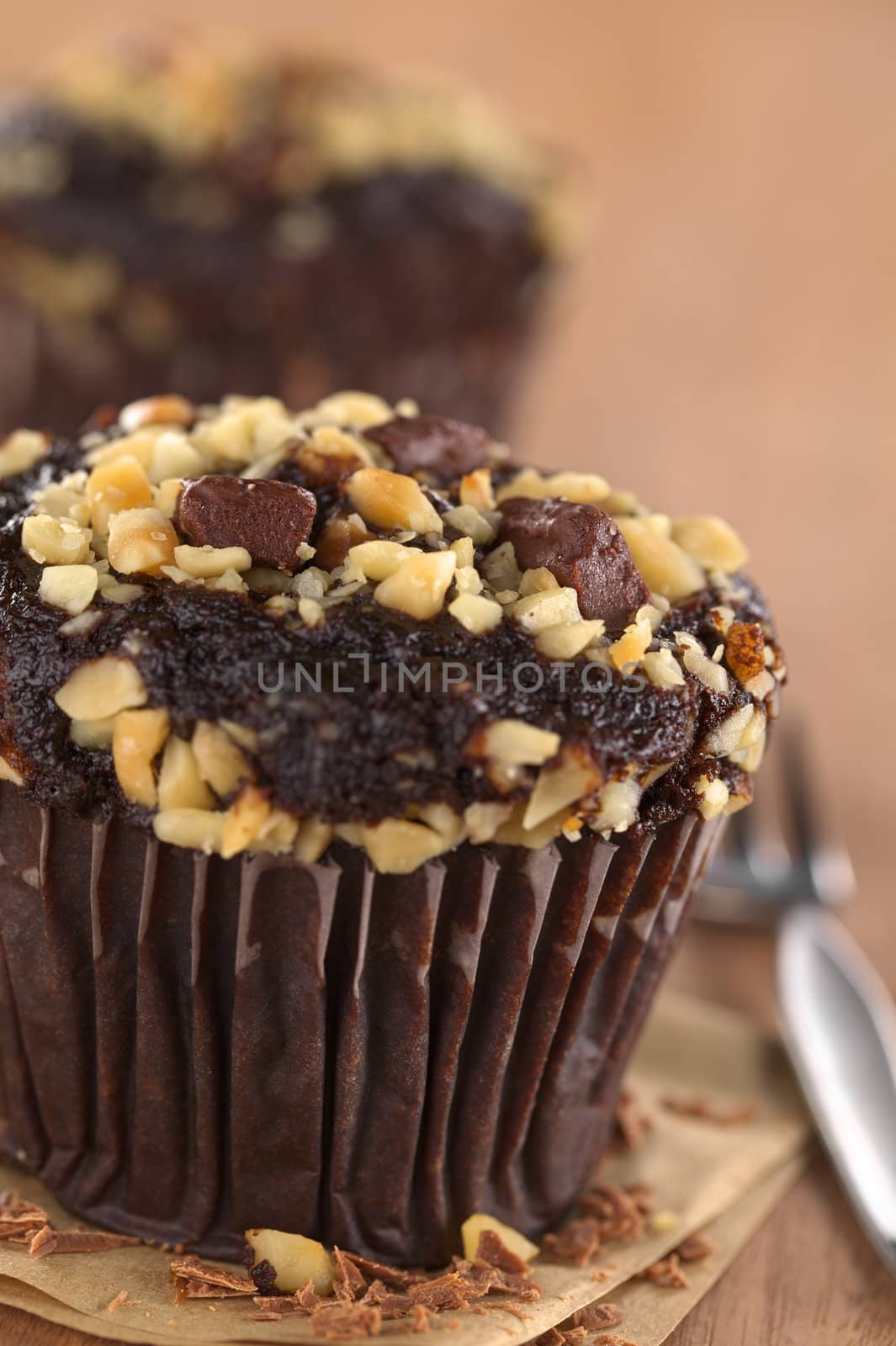 Chocolate-walnut muffins (Selective Focus, Focus on the two chocolate pieces in the front on the muffin) 