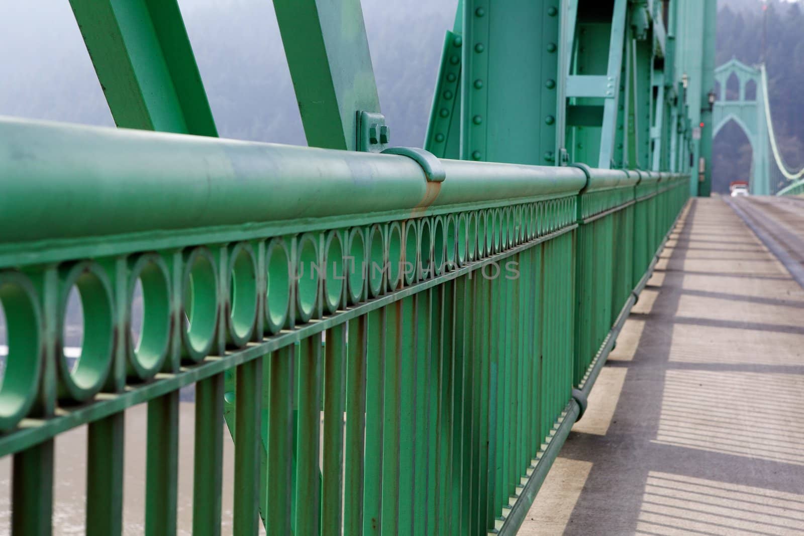 Green Railing perspective on St. Johns Bridge with view of one of the towers in soft background