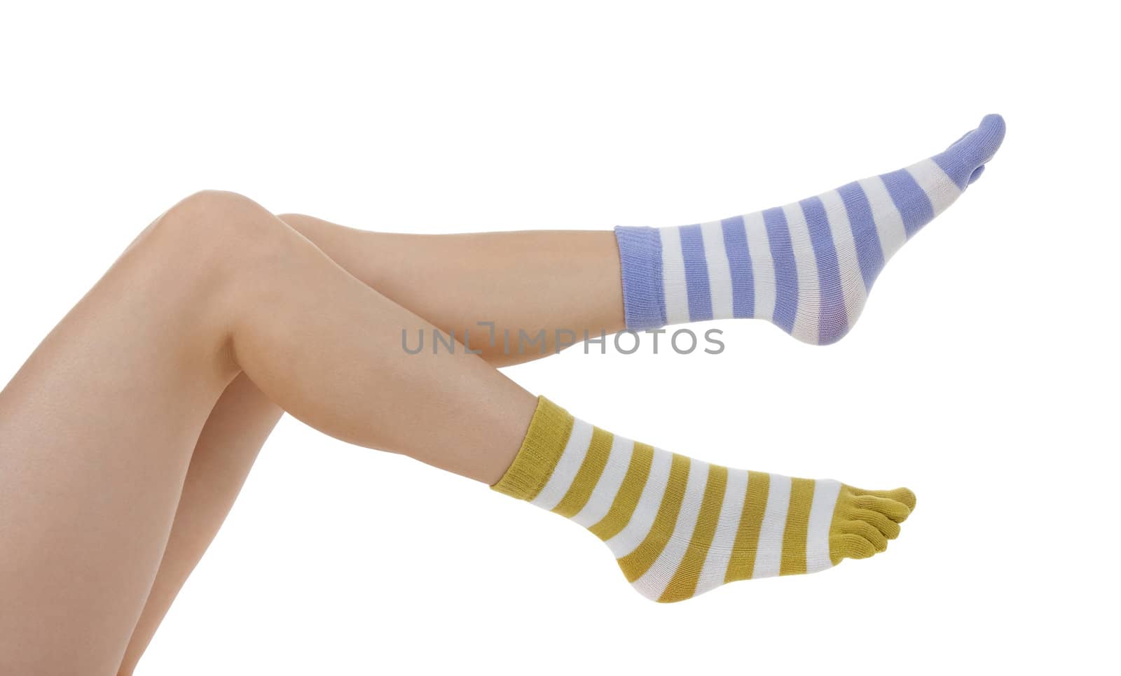 Sexy female legs in socks of different colors on white background.