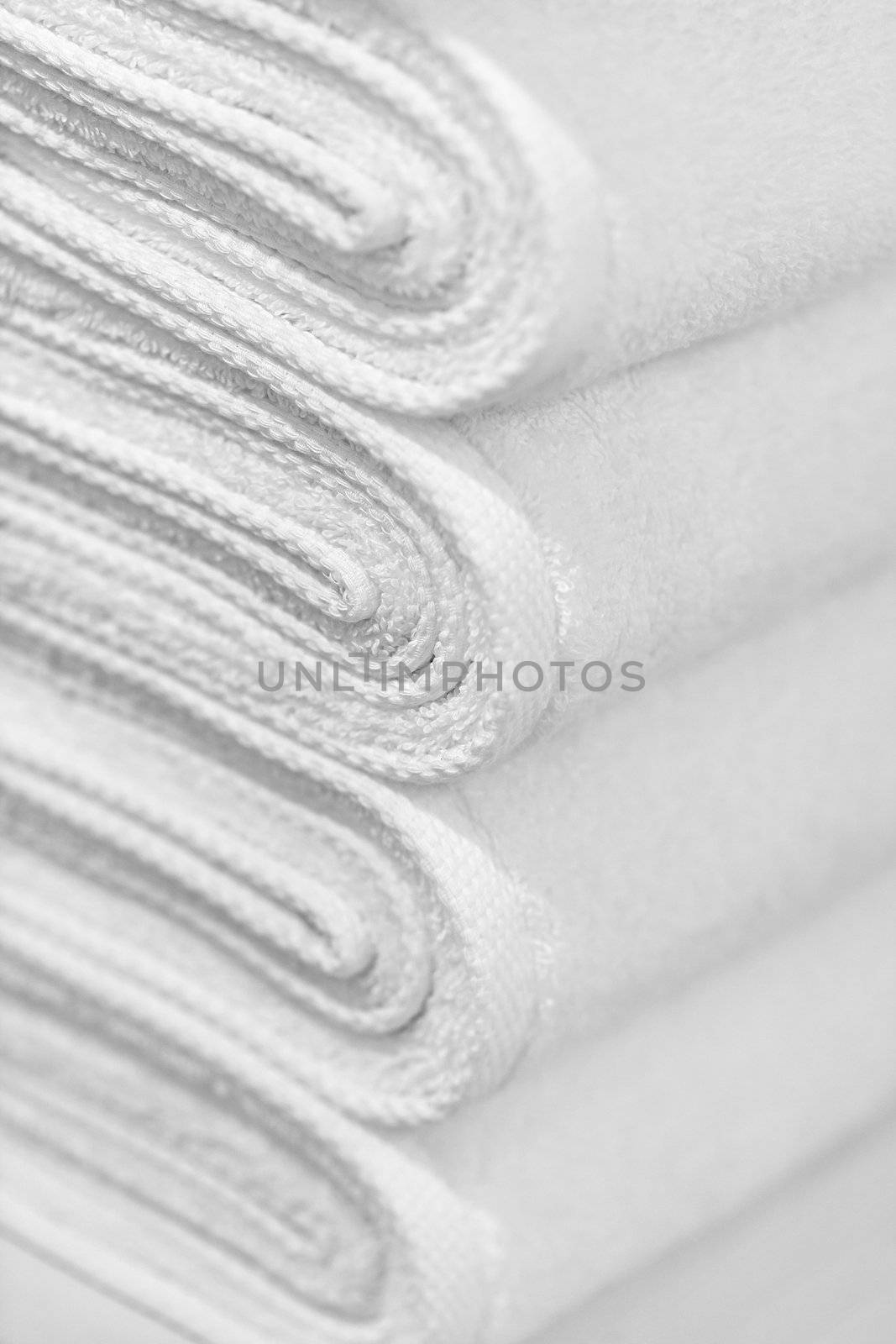 Stack of new white towels close-up - background by pzaxe