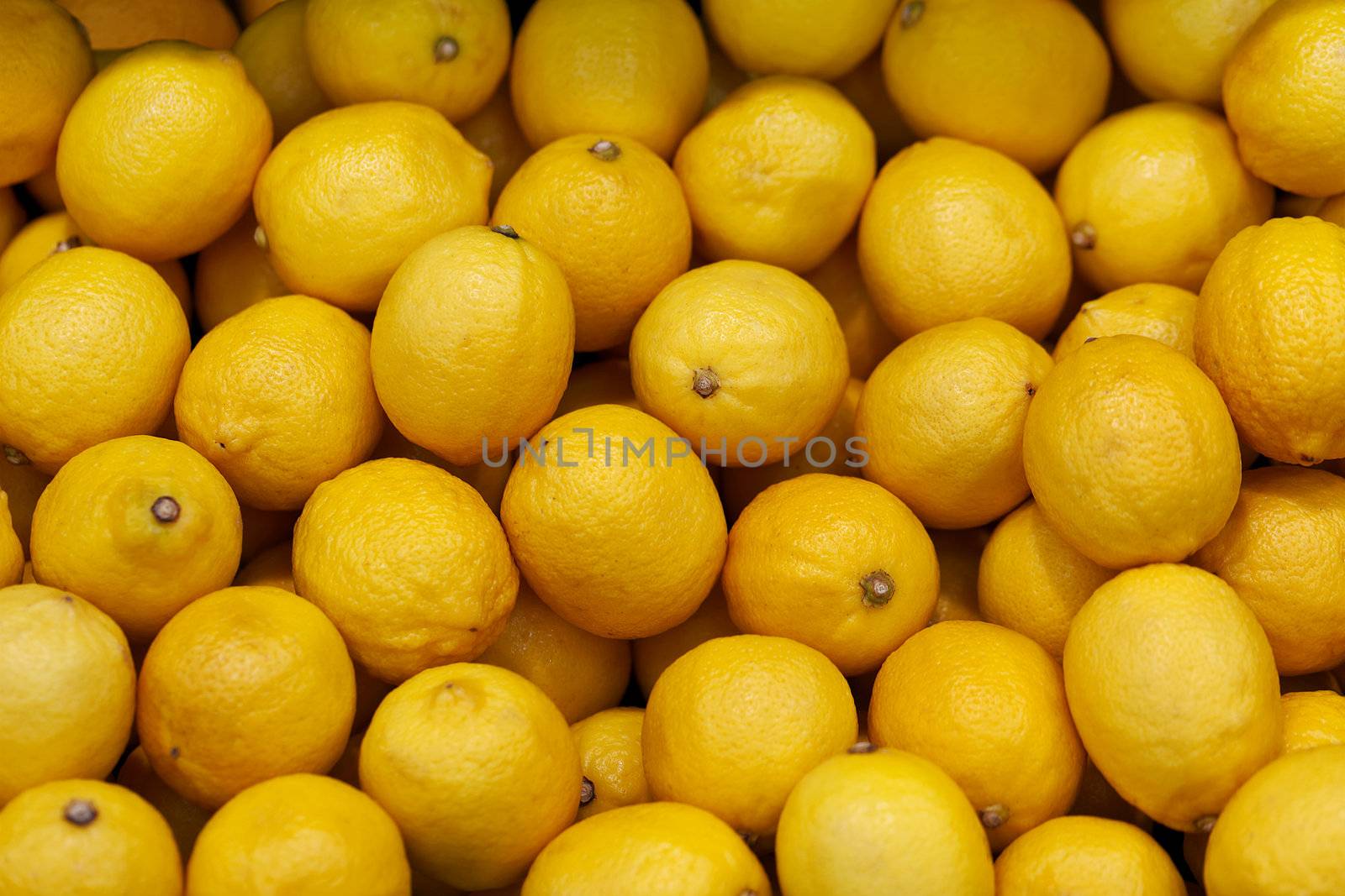 Lemons on the market counter - background by pzaxe