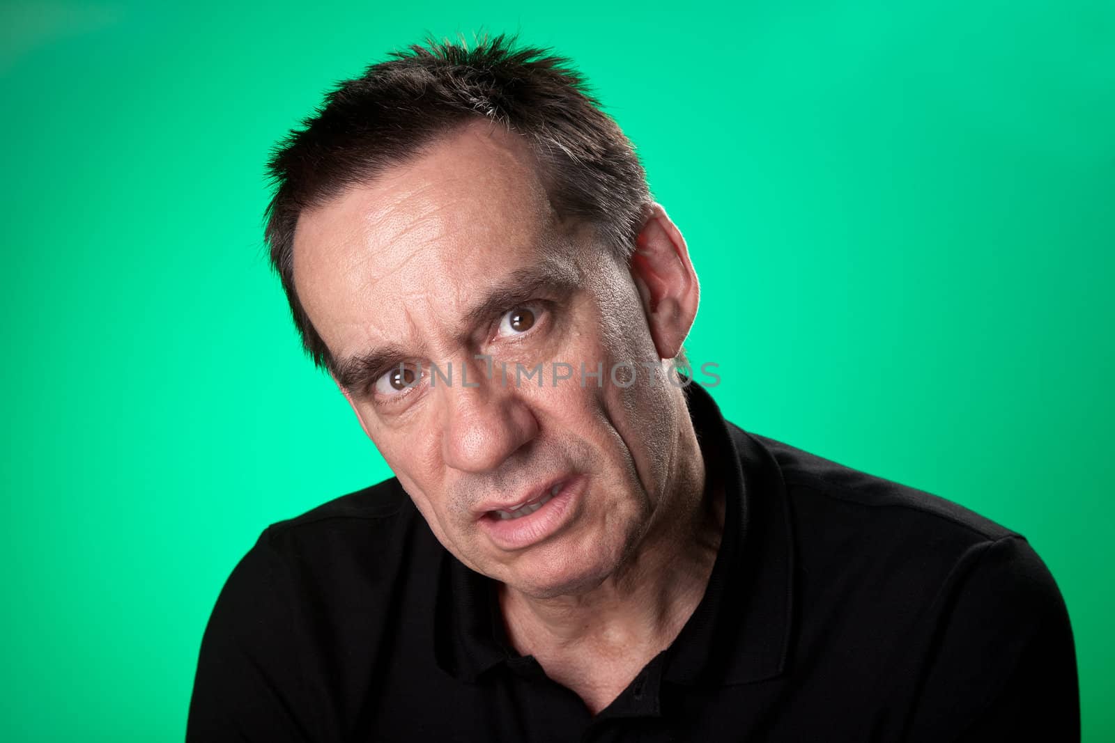 Man Looking Sick and Unhappy on Green Background by scheriton