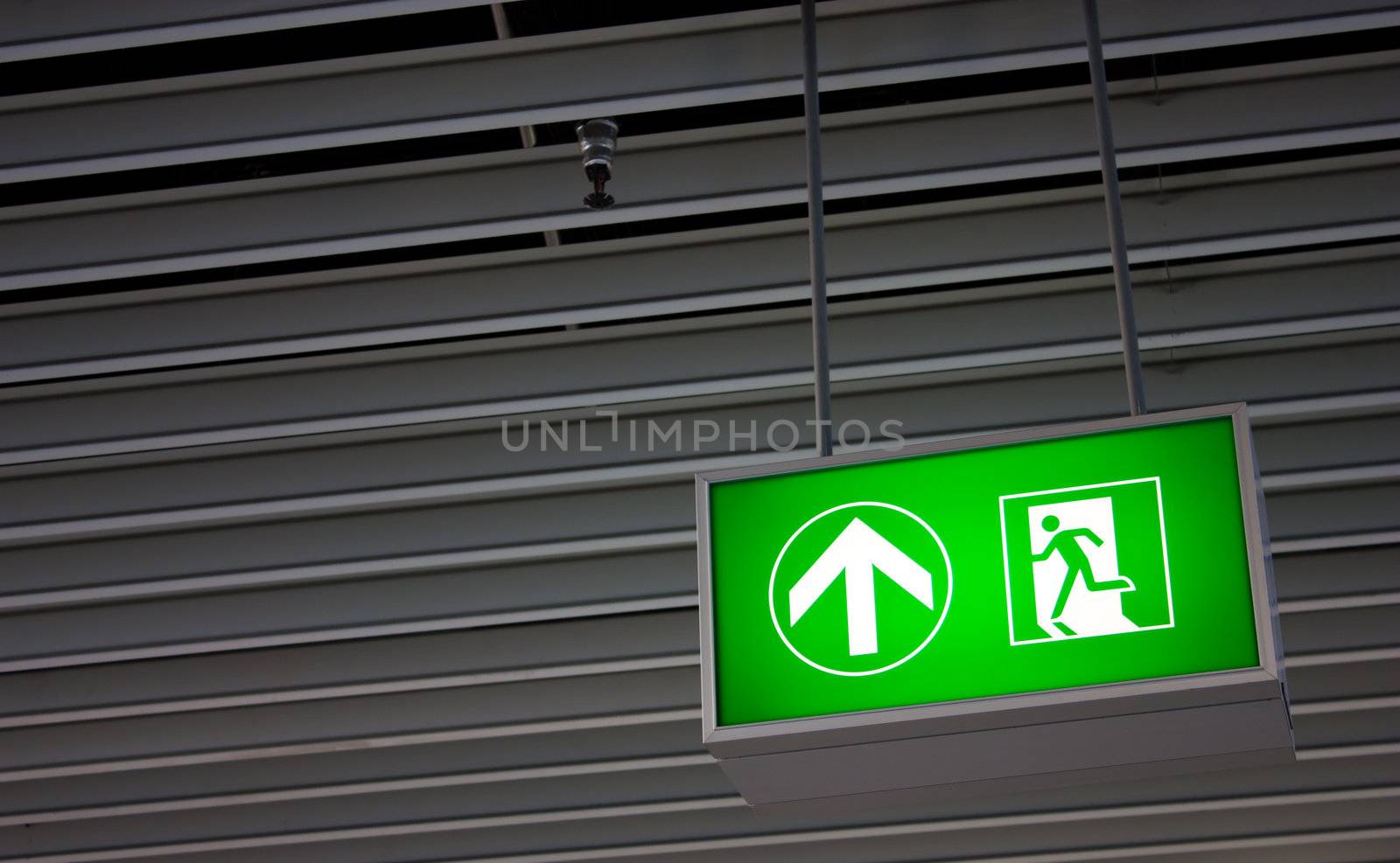 Emergency exit sign in modern offices inside an industrial plant