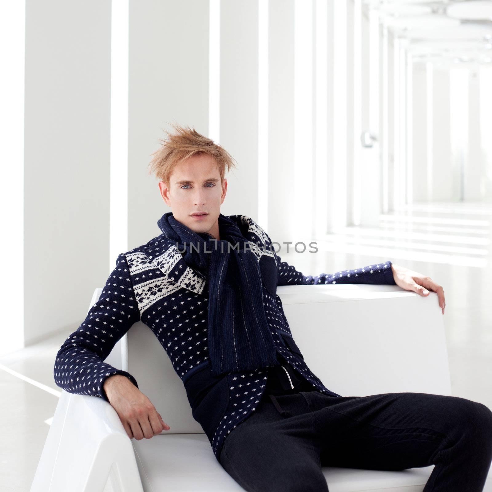 modern blond male futuristic sci-fi sitting in white indoor