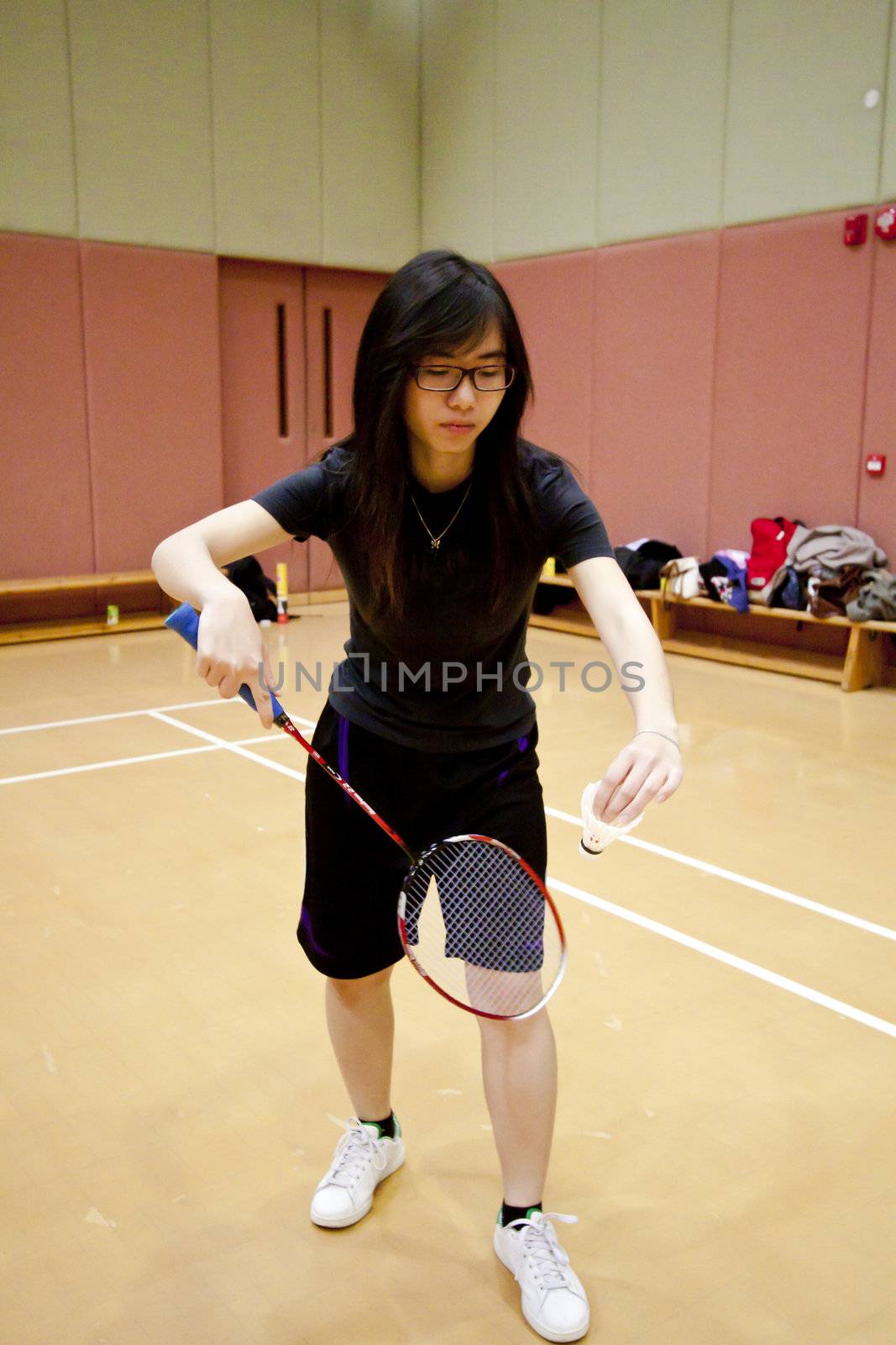 Asian woman playing badminton