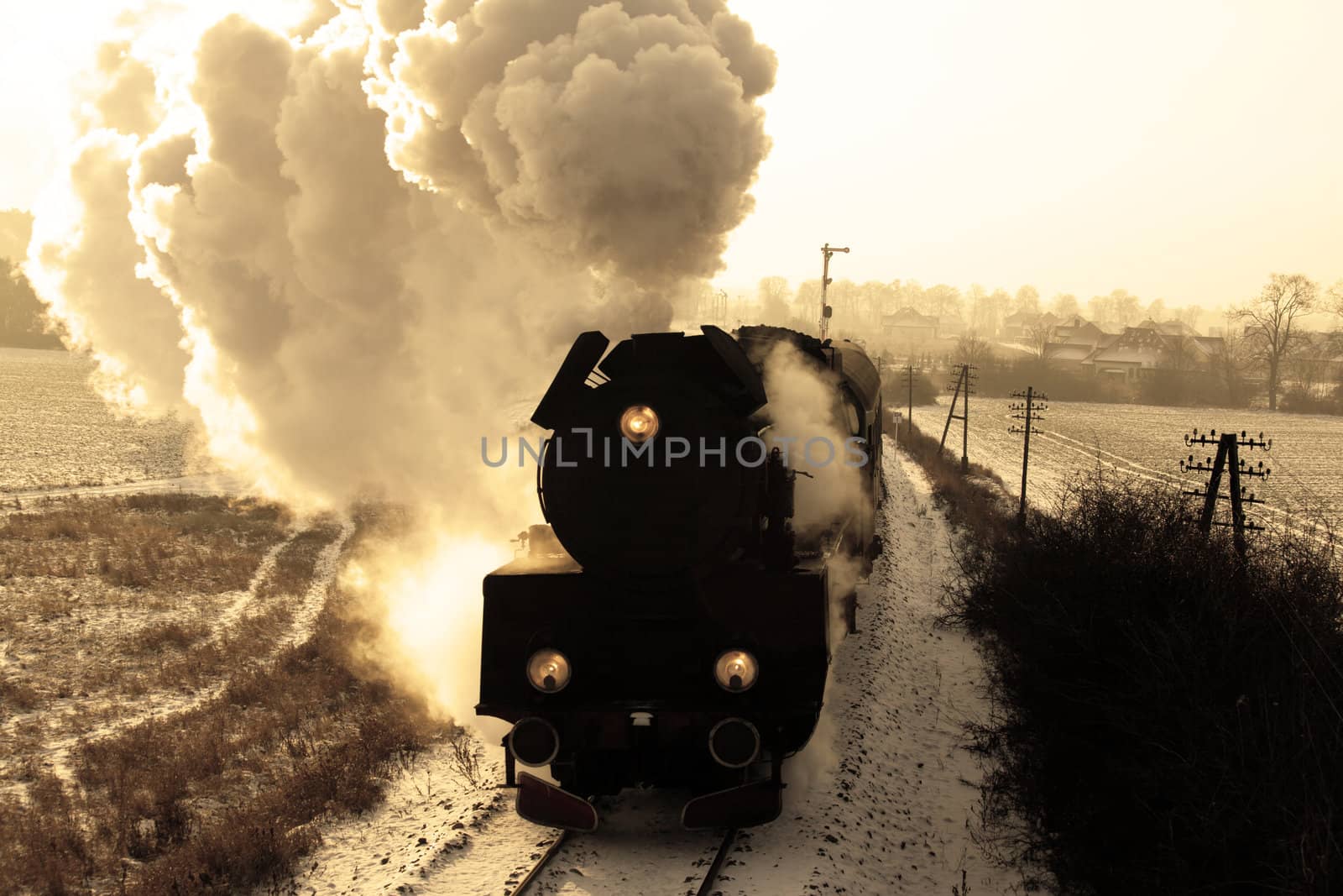 Vintage steam train starting from the station, wintertime
