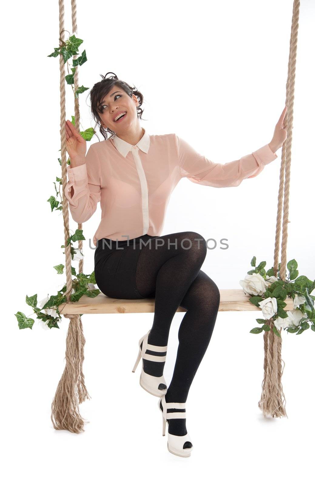 Emotional woman on a swing in the studio isolated background