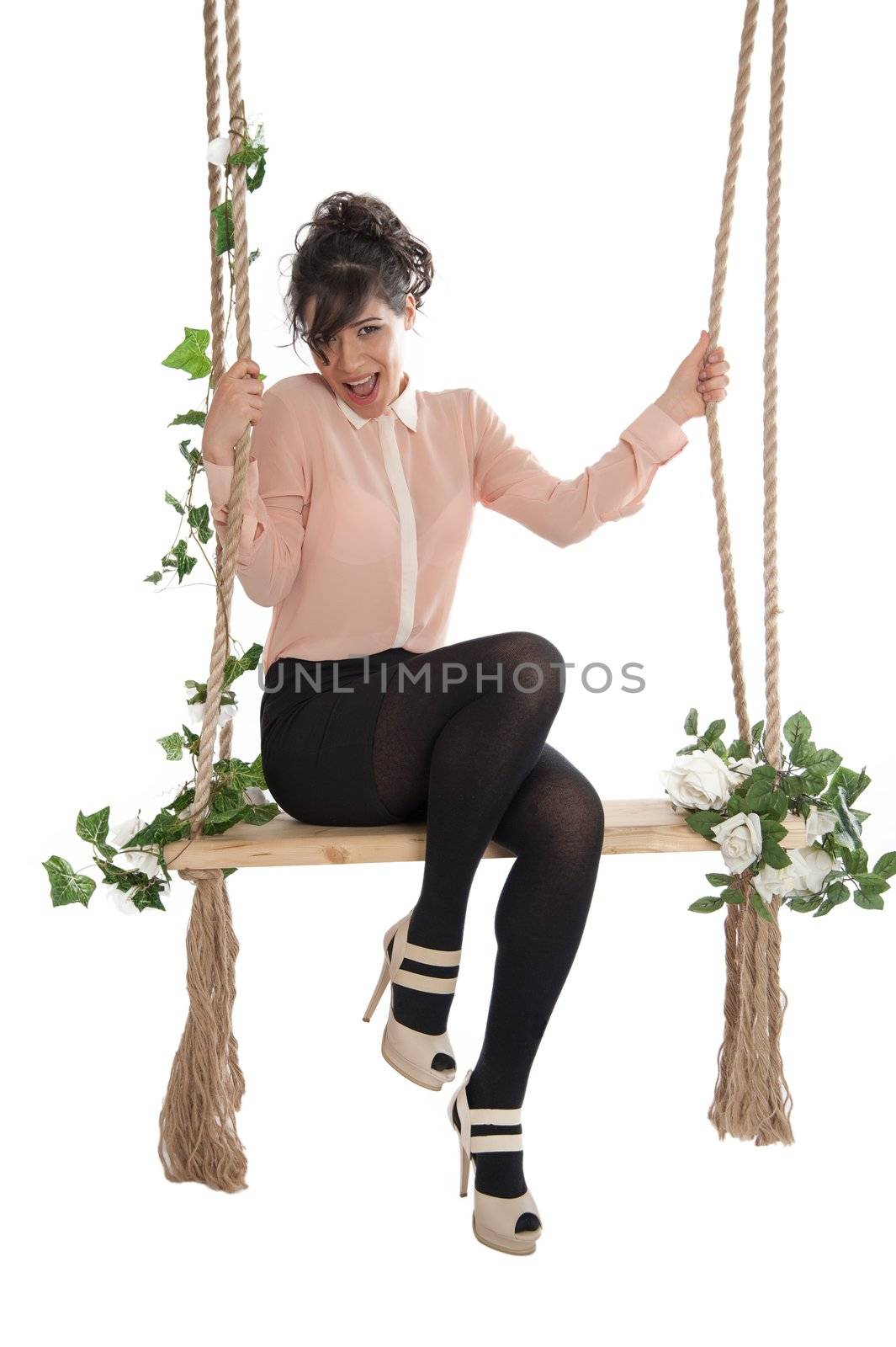 Emotional woman on a swing in the studio isolated background