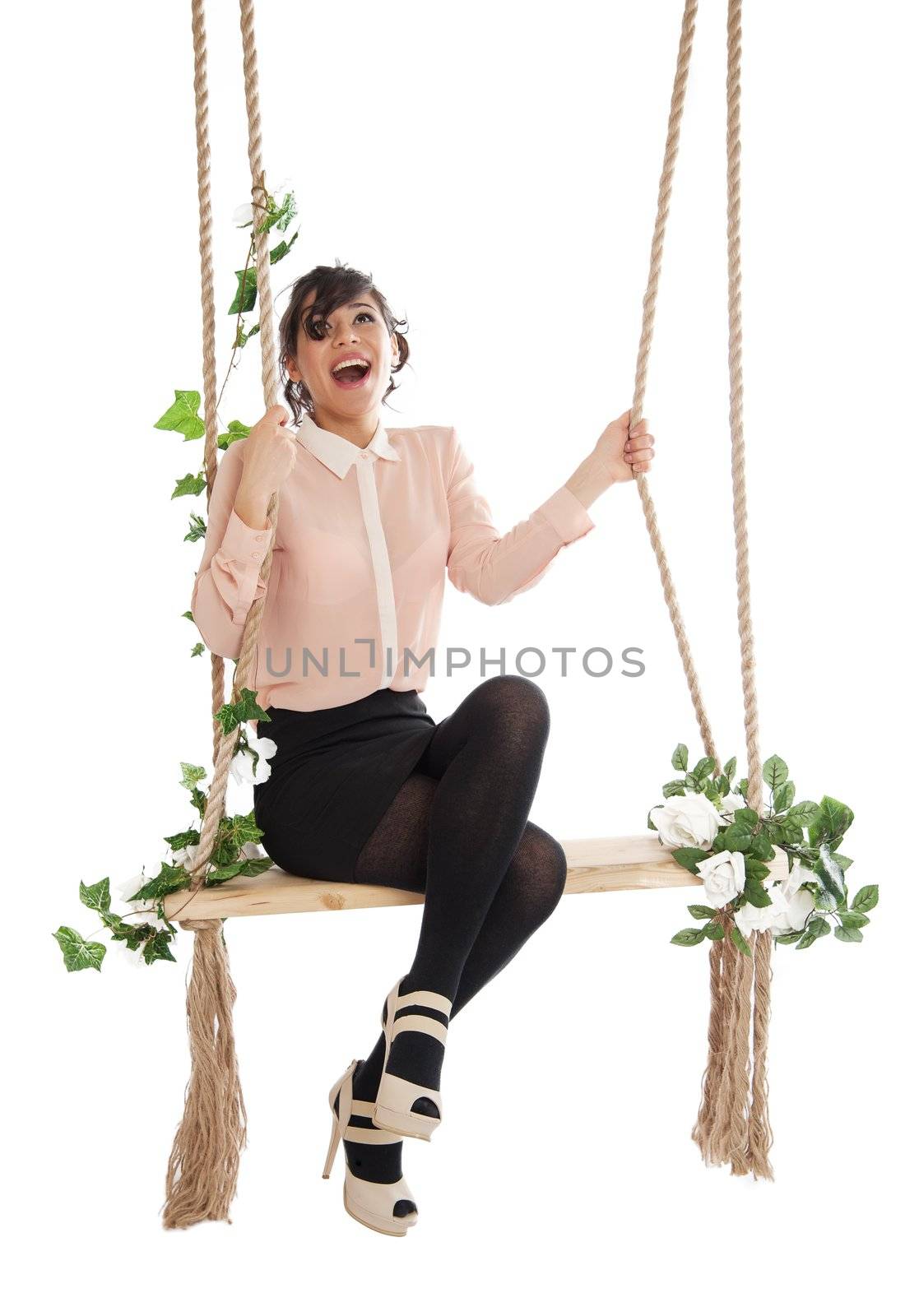 Emotional woman on a swing in the studio isolated background