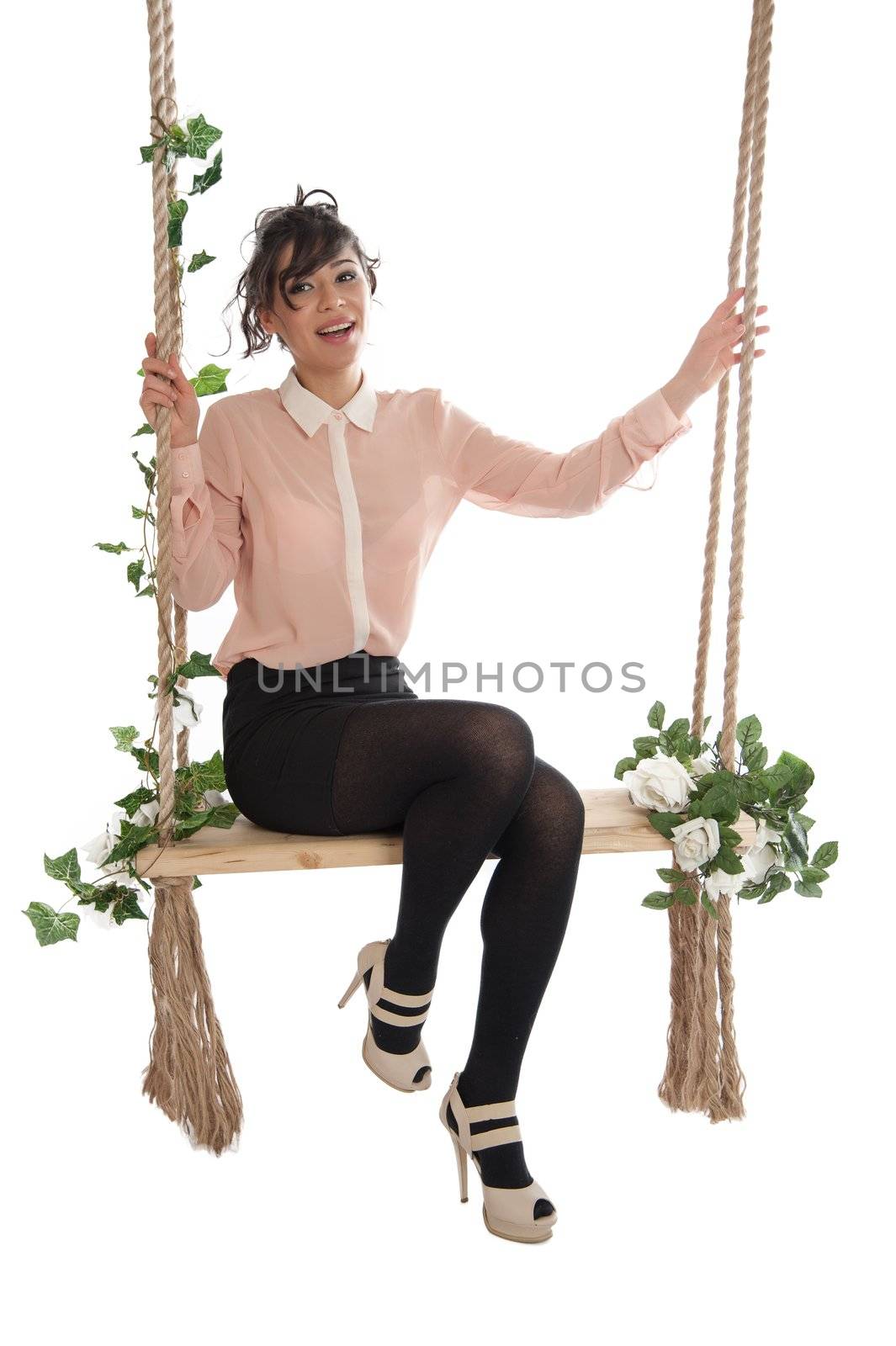 Emotional woman on a swing in the studio isolated background