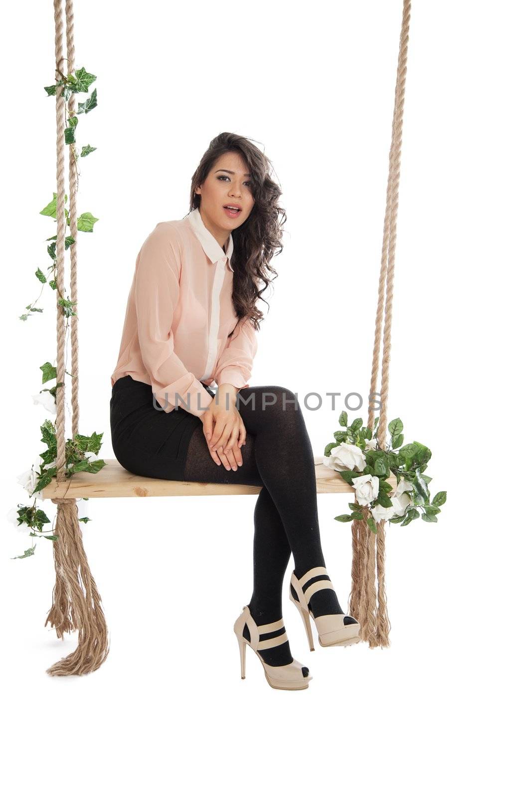 Emotional woman on a swing in the studio isolated background