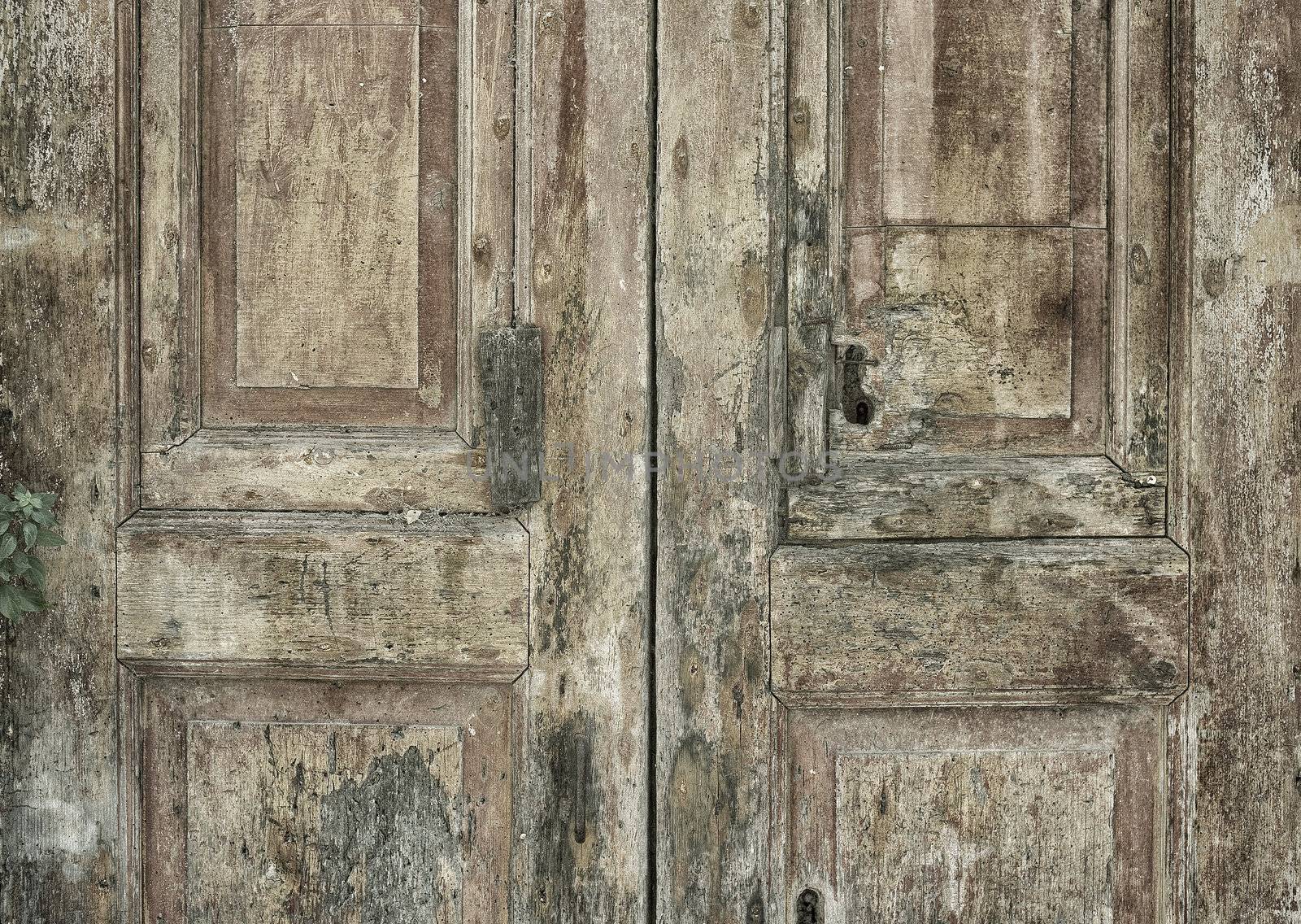Very old wooden door in decay - Sassi - Basilicata, Italy.