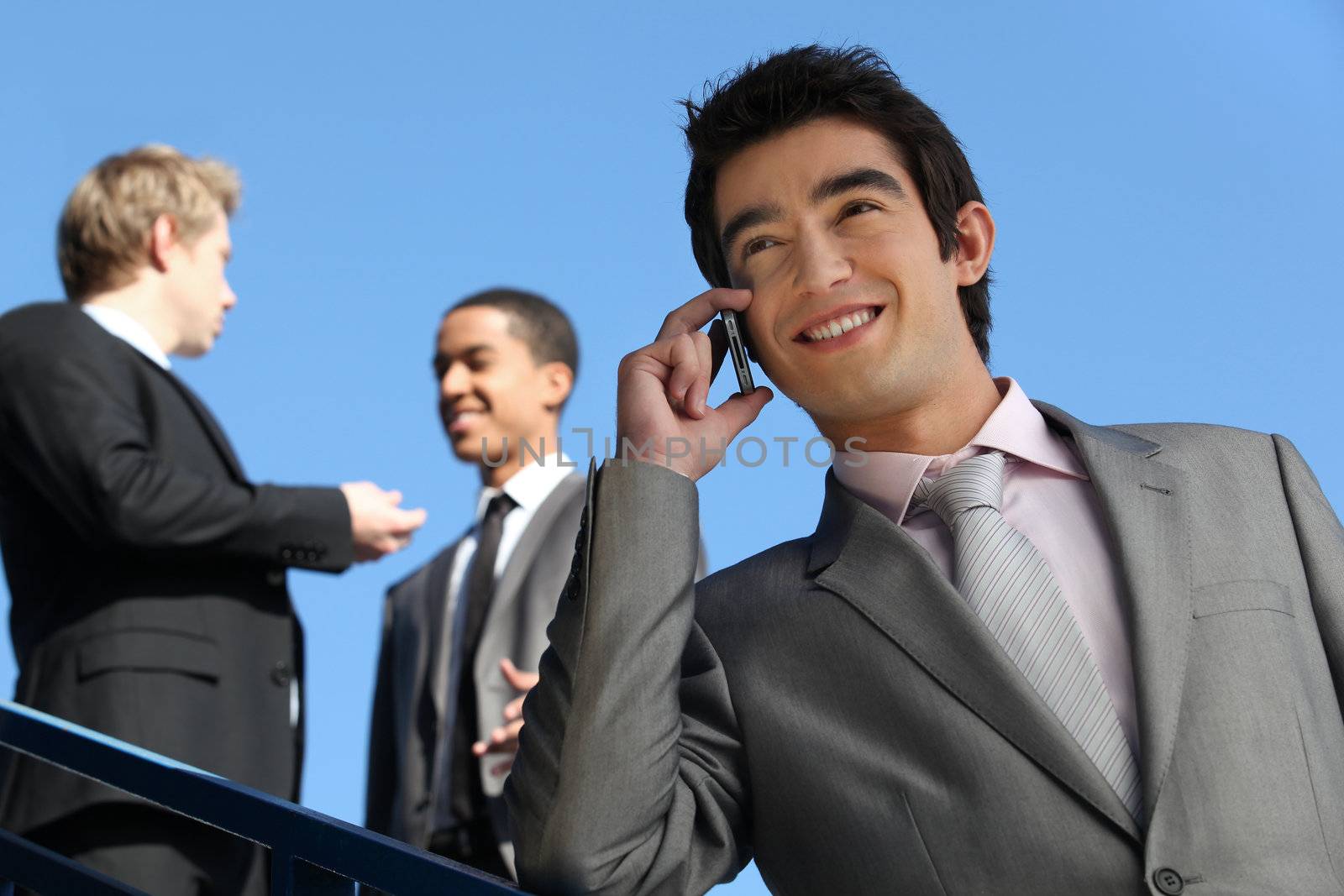 junior businessman on the phone outdoors