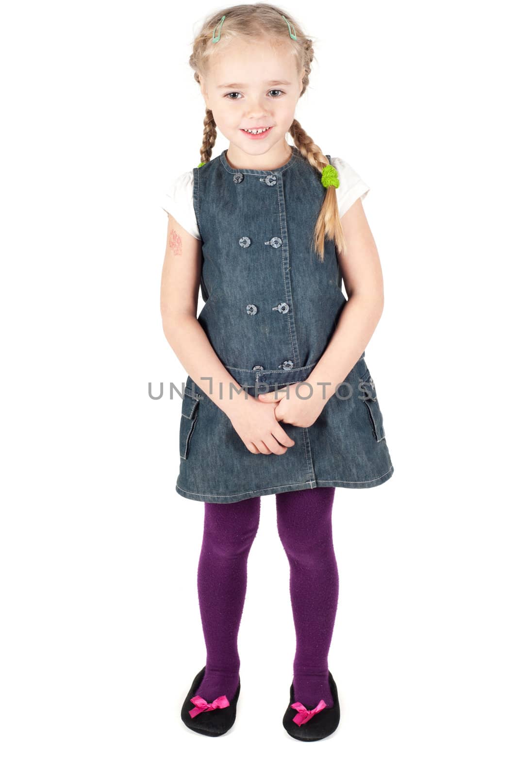 Studio portrait of little cute girl in denim dress