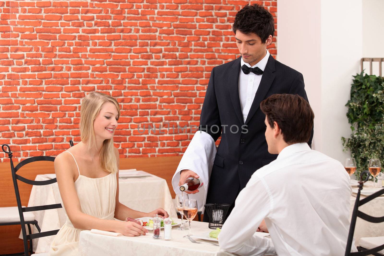 waiter serving couple by phovoir
