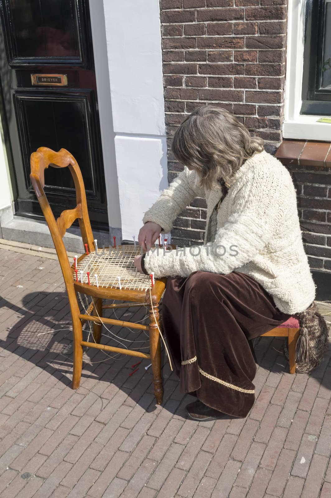 BRIELLE,HOLLAND APRIL 01:Man braids chair on April 01, 2013 in Brielle,Holland.This is the party of the point in the uprising of Low Countries against Spain in the 80 Years' War