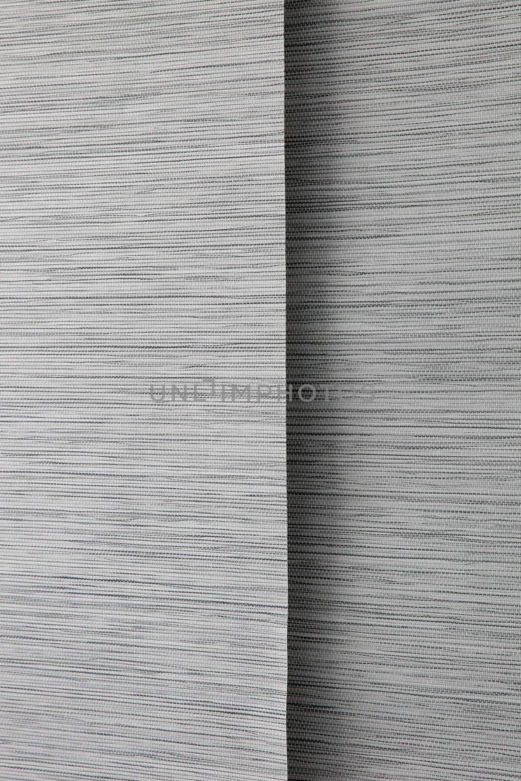 Close-up image of black, grey and white colored blinds.