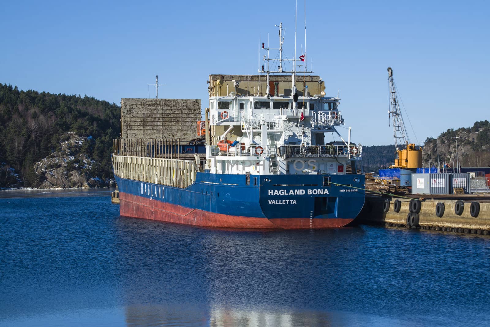 MV Hagland Bona is docked at the port of Halden, Norway and unloading timber. The picture is shot one day in March 2013.