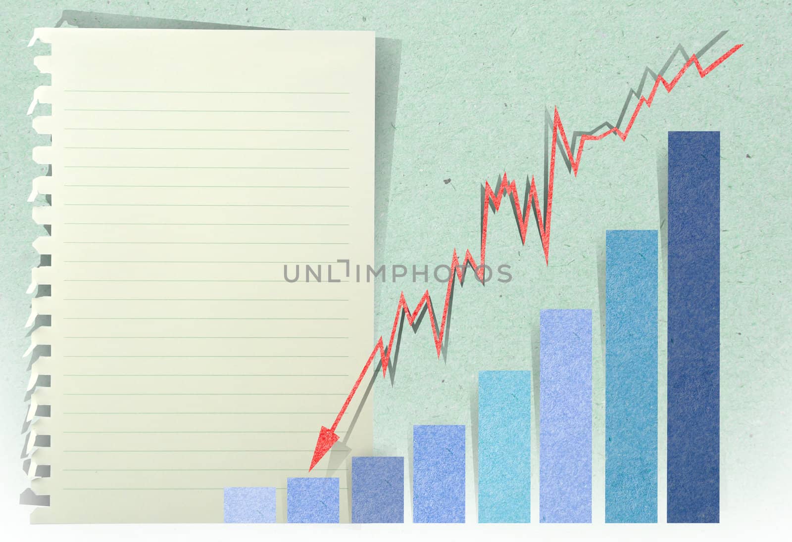 arrow graph going down with staple recycled paper craft stick