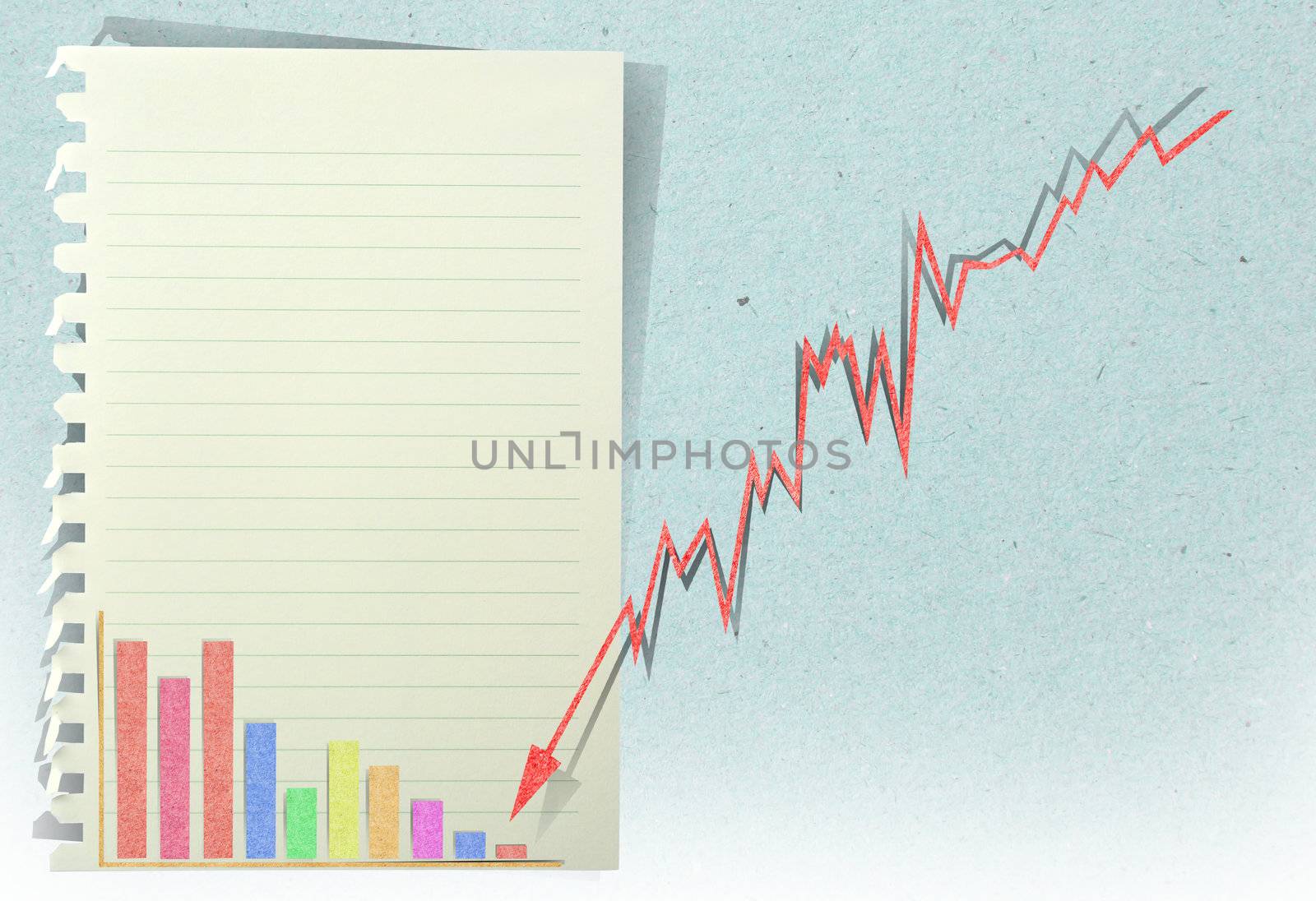 arrow graph going down with staple recycled paper craft stick