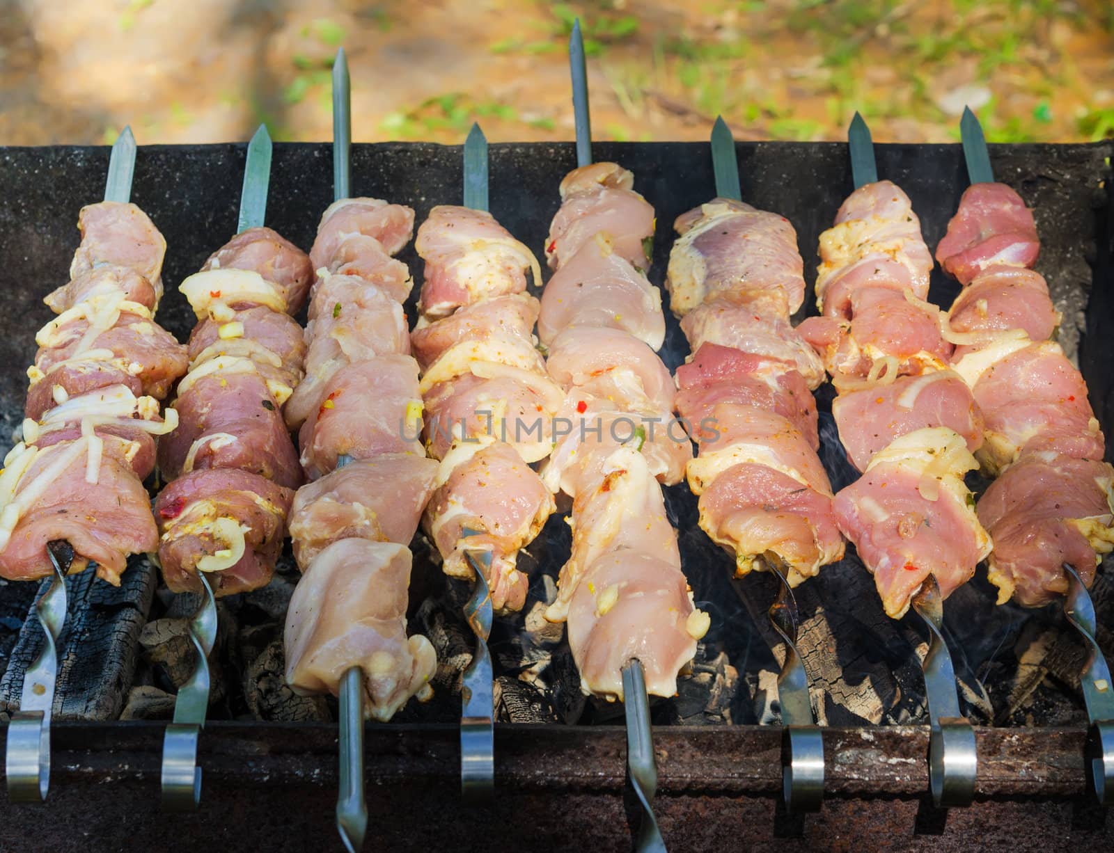 many roast meat pieces on skewer. shish kebab cooking process by docer2000