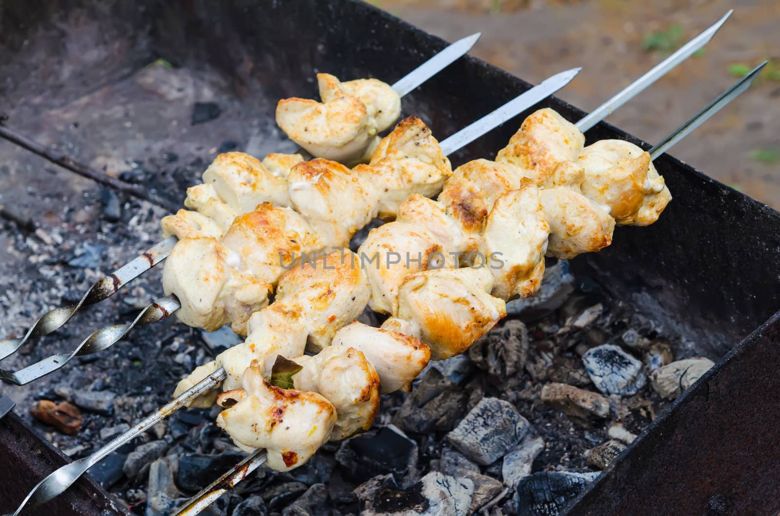 many roast meat pieces get on skewer. shish kebab cooking by docer2000