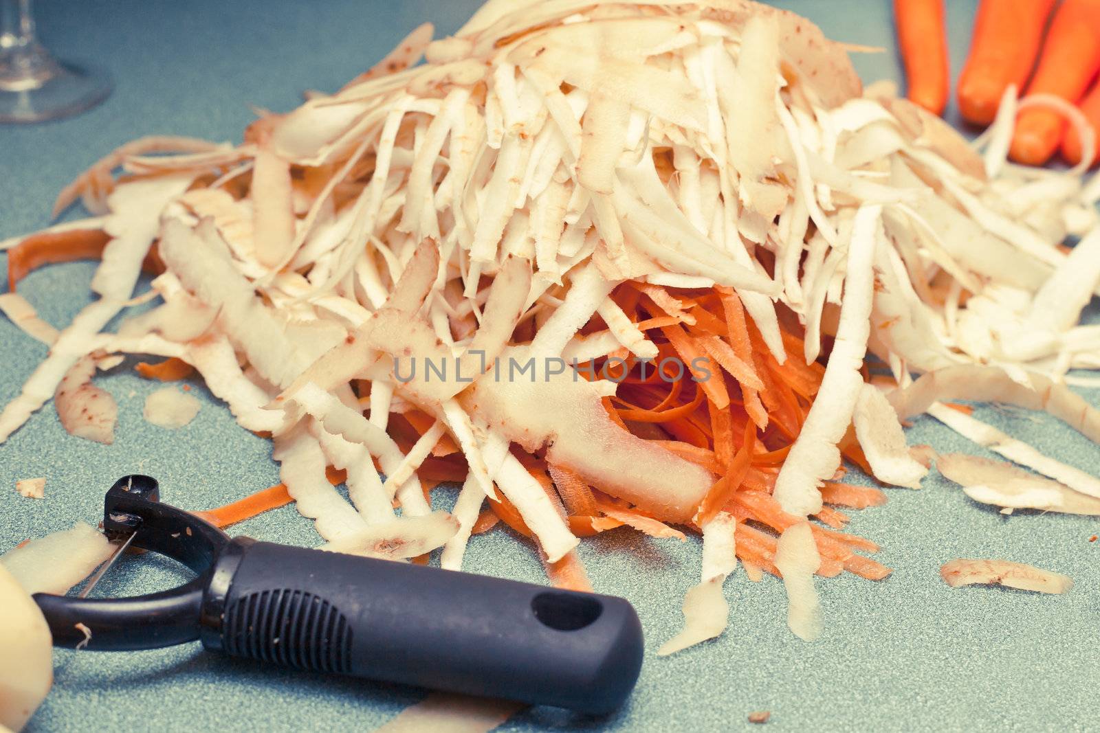 Potato and carrot peelings on a worktop