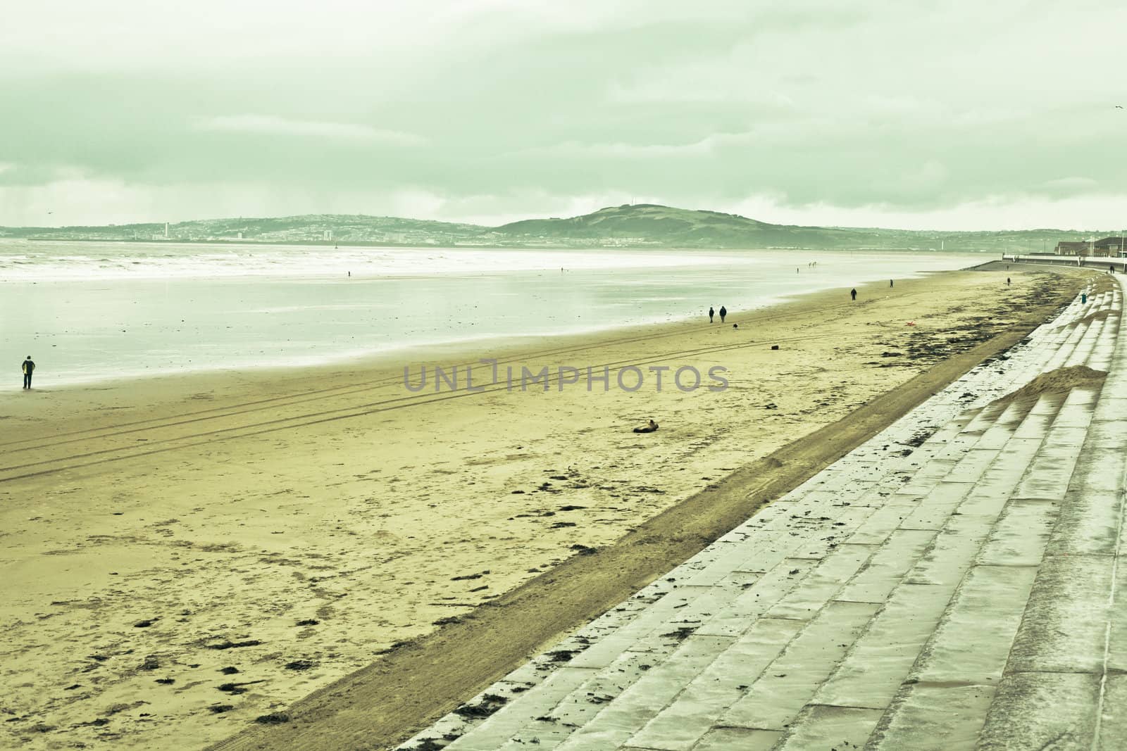 View of aberafan beach in South Wales in winter, with Swansea city on the distance