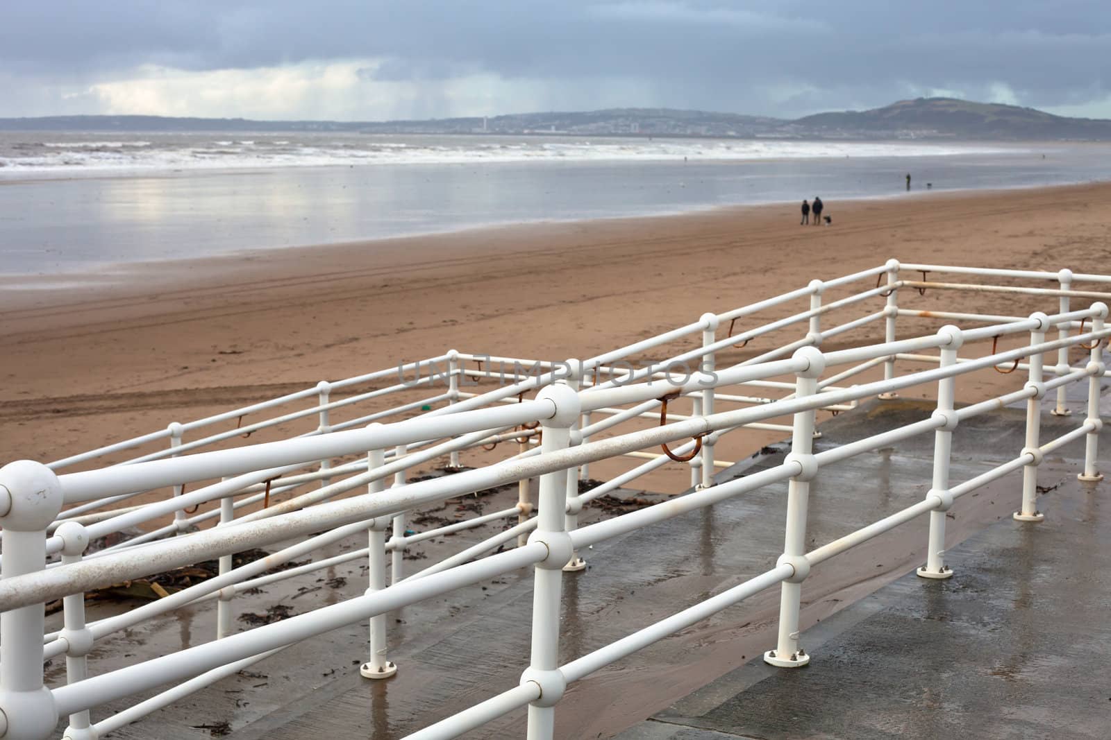 view of aberafan beach in South Wales in winter, with Swansea city in the distance
