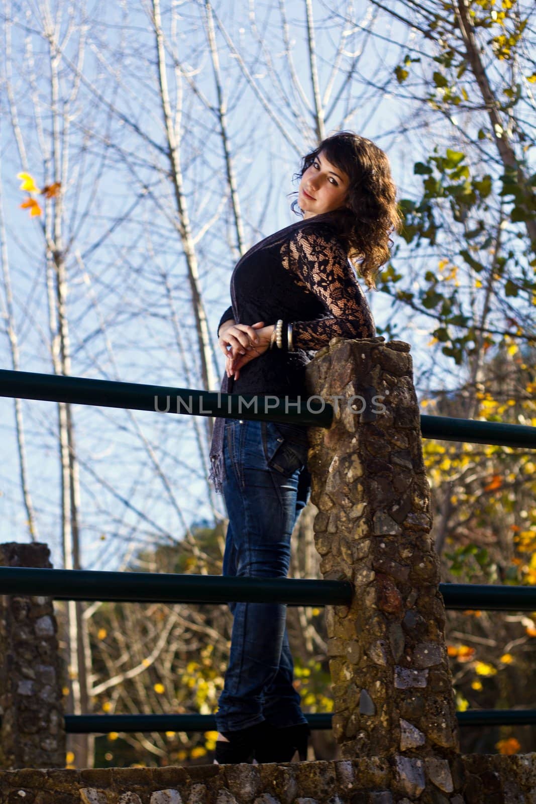 View of a beautiful girl on a urban park on a autumn set.