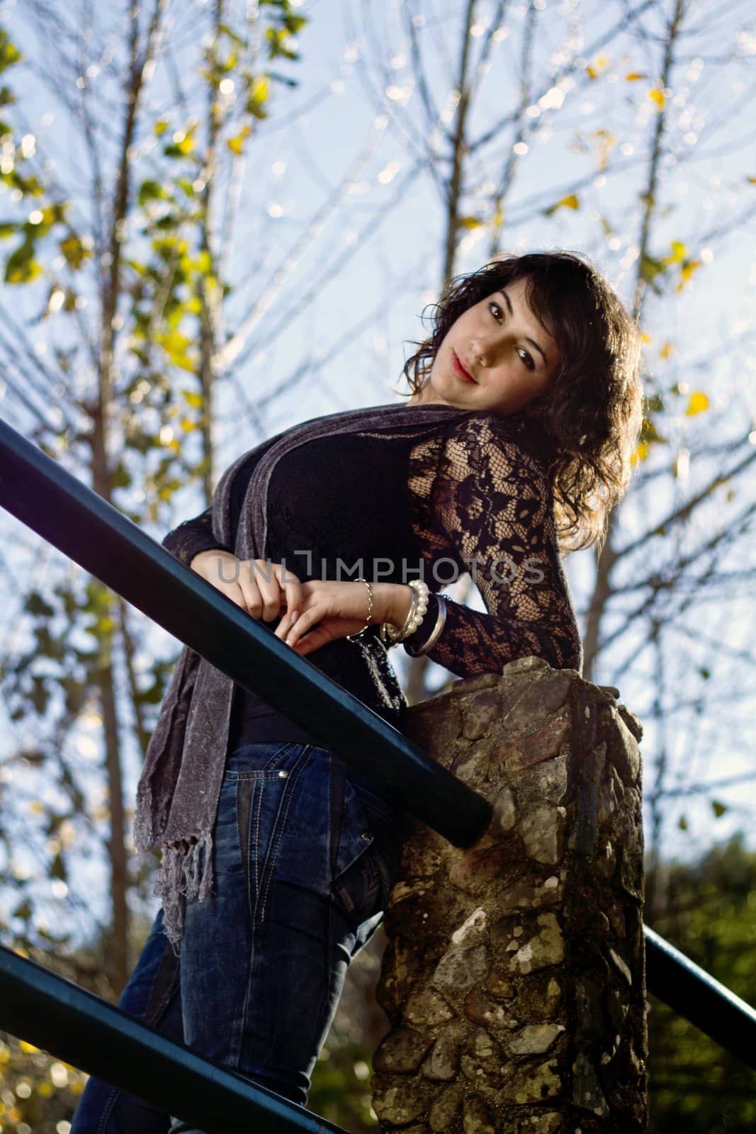 View of a beautiful girl on a urban park on a autumn set.